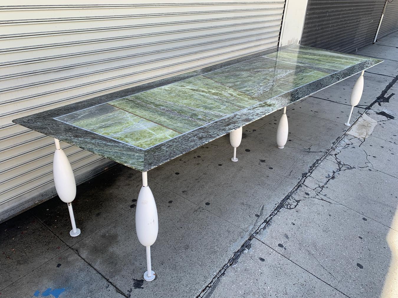 Monumental custom post-modern dining table with painted metal base and marble top by Sema Topaloglu, Turkey, 1990s.

The table has an assymetrical shape measuring just over 11 ft in length.

The base is made in solid steel powder coated in white