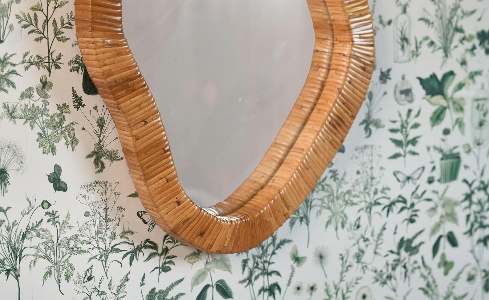 Discover the allure of asymmetry with this lovely Mirror! The organic rattan cane frame adds a distinctive shape, creating a magnificent focal point in any living room, bedroom, or entryway. Enhance your space by easily mounting it on your wall.