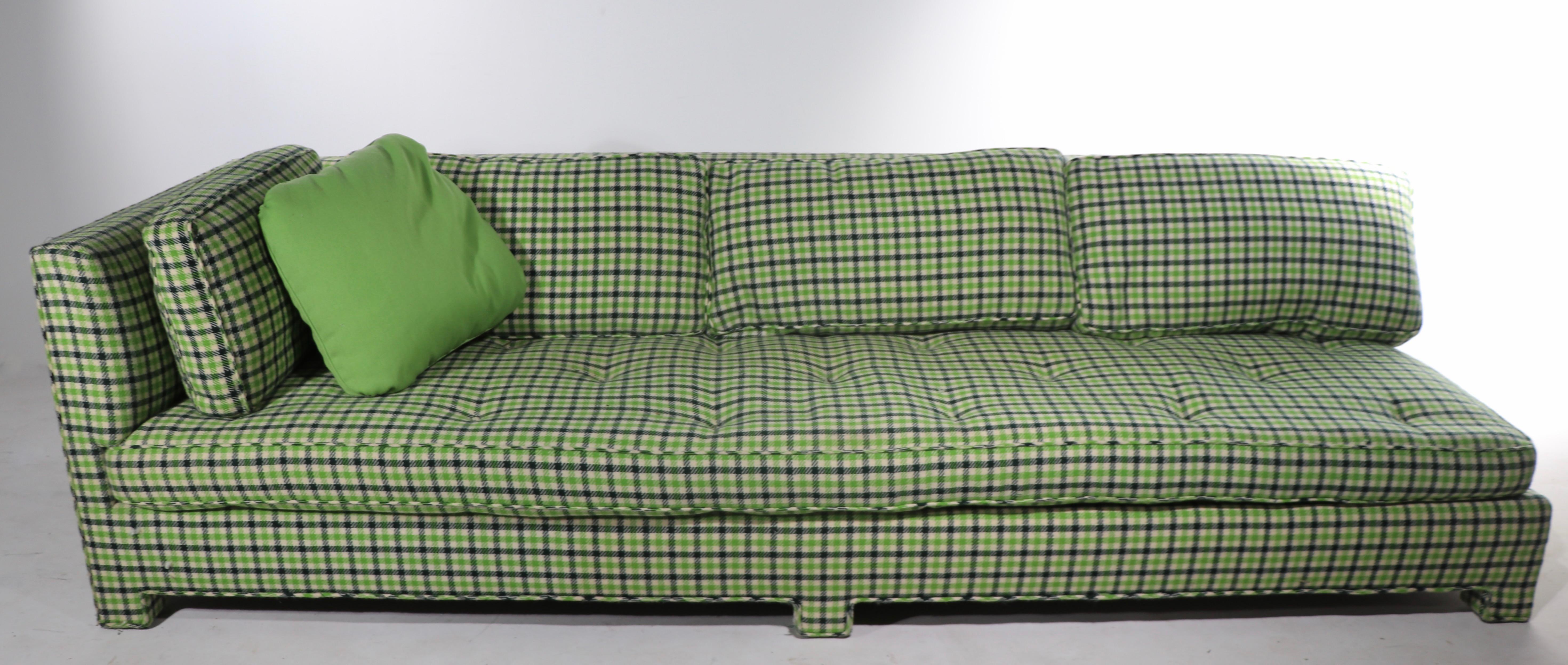 Schickes, architektonisches und modisches asymmetrisches Sofa des bekannten Herstellers Thomas De Ángelis. Eine Seite des Sofas ist mit einem geraden Arm ausgestattet, die andere Seite ist armlos. Strukturell solide und robust, weist der Stoff