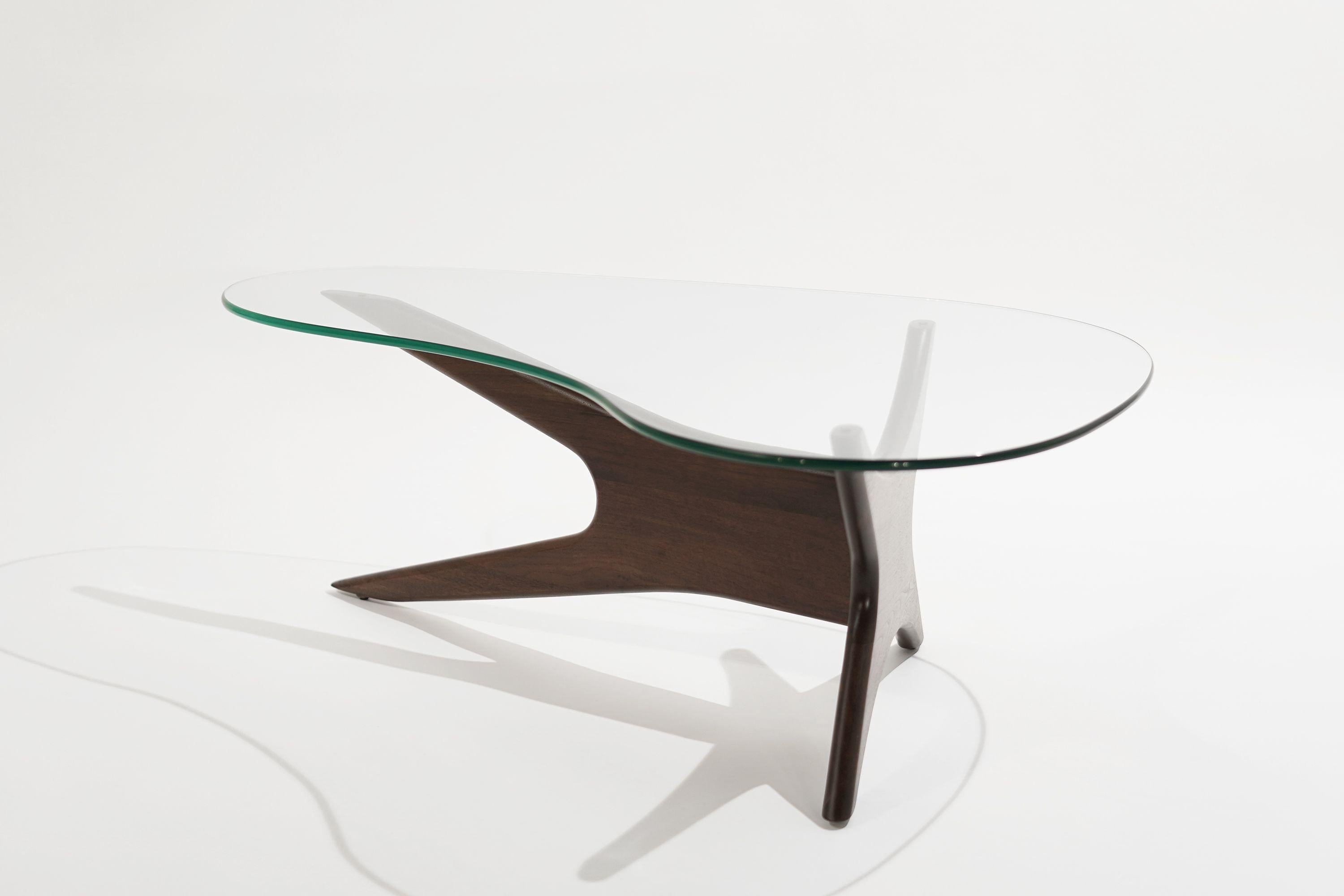 Biomorphic walnut and glass coffee table by Adrian Pearsall for Craft Associates, circa 1950s.
Sculptural walnut base fully restored. New custom-made kidney-shaped glass top.

Other designers from this period include Ico Parisi, Vladimir Kagan,