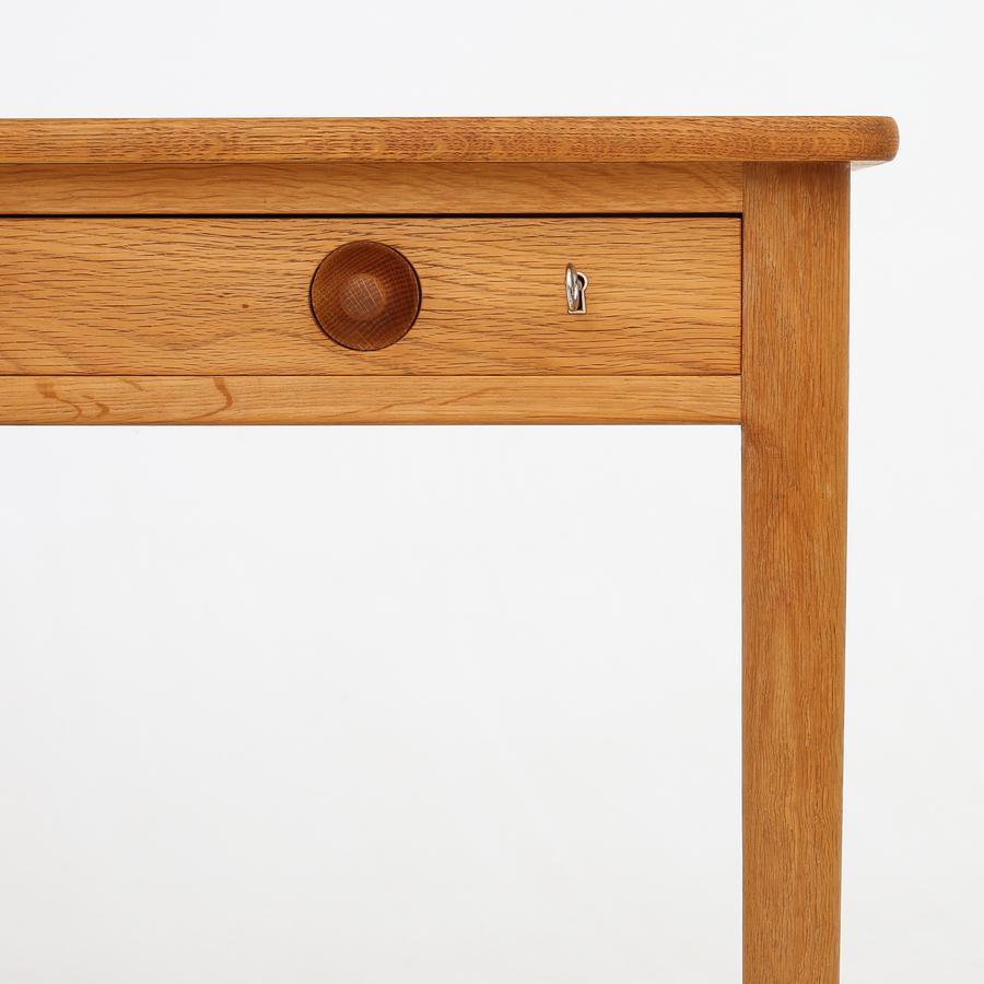 AT 305 - Desk in oak with three drawers and teak details. Maker Anders Tuck.