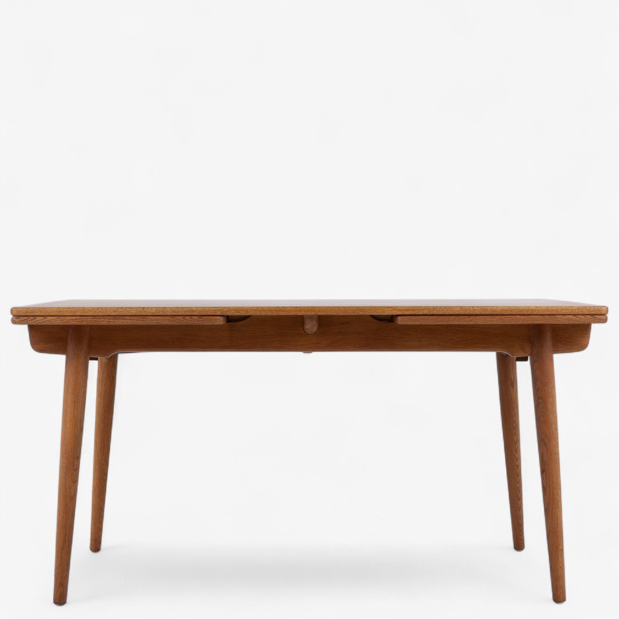 AT 312 - Dining table in patinated oak with Dutch extension. Stamped from manufacturer.