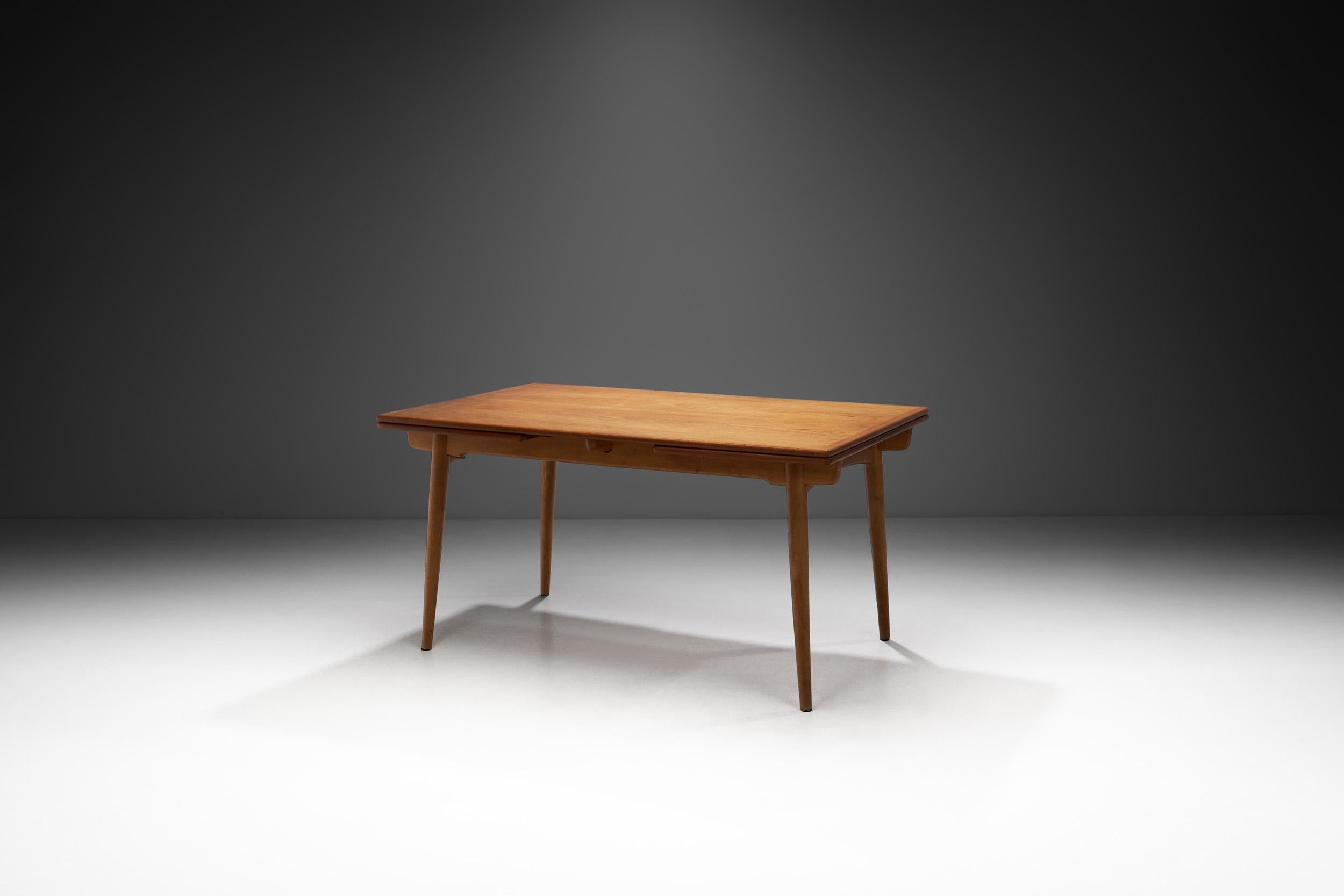 This oak and teak “AT-312” dining table was designed by Hans Wegner in the 1950s and its title of ‘iconic’ is well deserved. Created by a designer who is credited as one of the main driving forces of the mid-century Danish modern movement, this