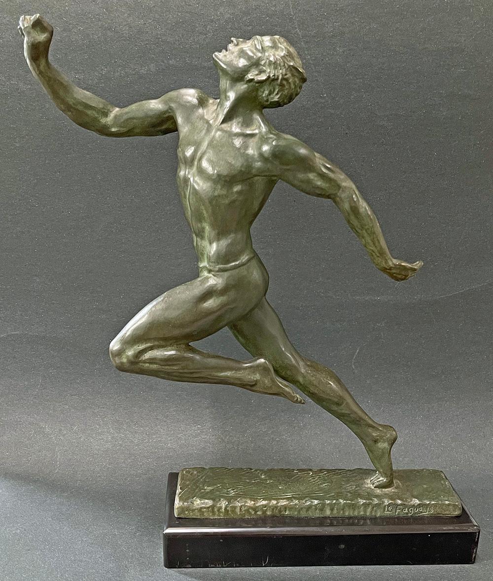 Beautifully cast and finished with a verdigris patina, this extremely rare bronze by Pierre Le Faguays depicts a nude runner racing at top speed, his head thrown up in relief and exaltation as he crosses the finish line, his lithe limbs straining at