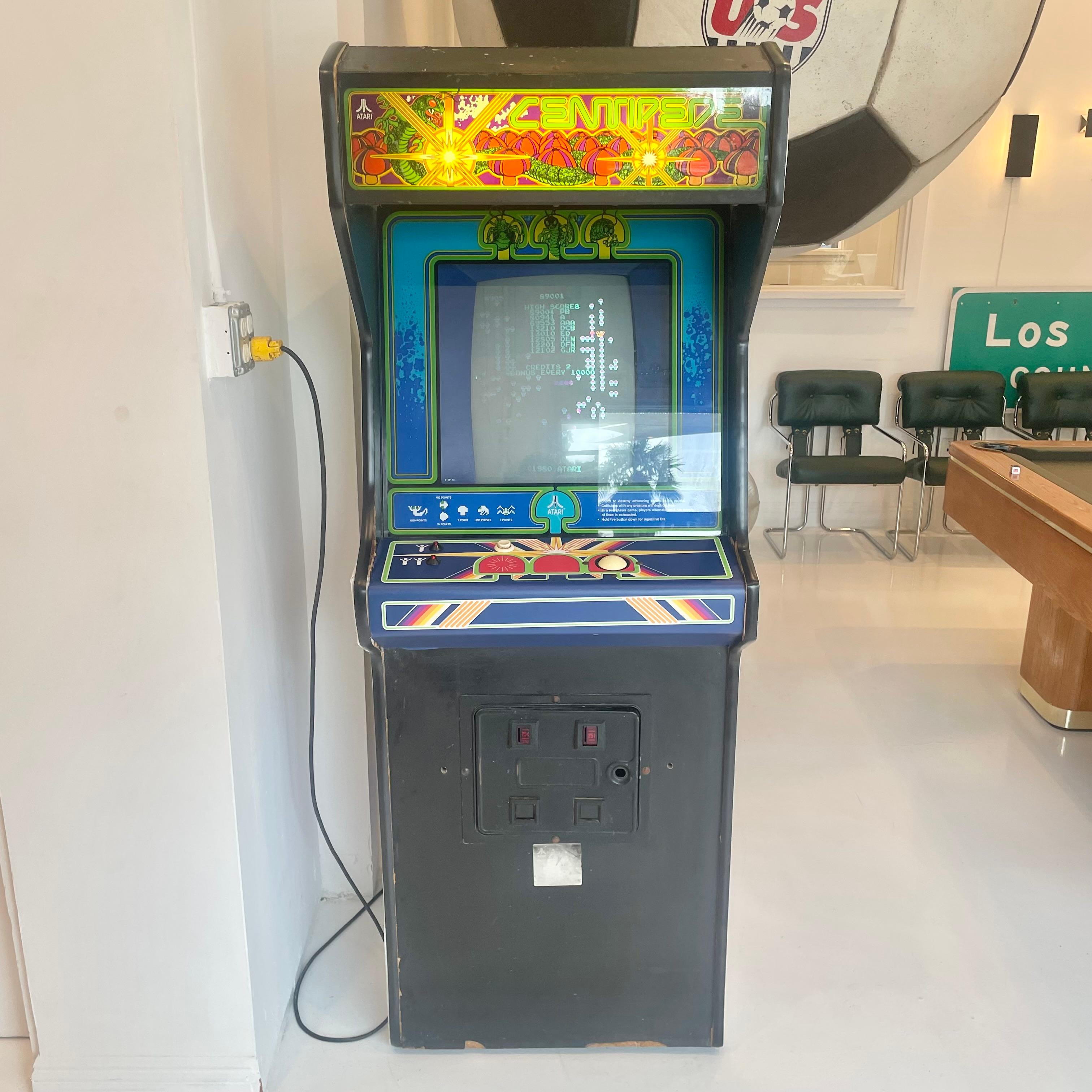 Vintage 'CENTIPEDE' arcade game from 1980. Made by Atari and designed by Dona Bailey and Ed Logg. In excellent working condition. Great alien and intergalactic visuals as well as classic fixed shooter sounds. Extremely fast paced game speed and very