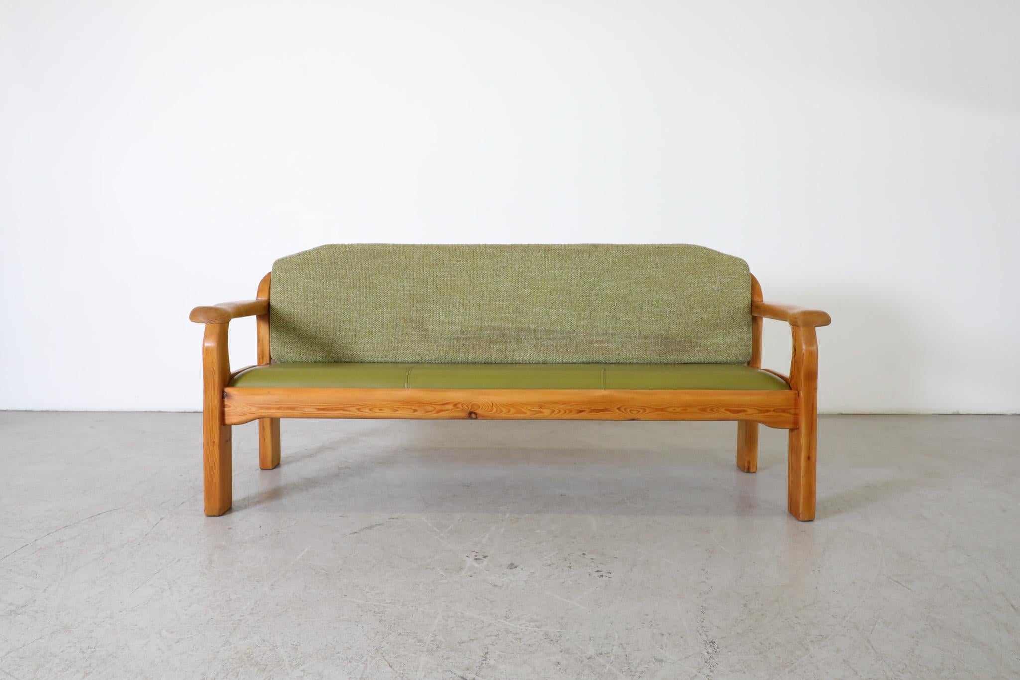 Ate van Apeldoorn style three seat pine bench with green skai seat and newly upholstered green fabric back cushion. An attractive piece with rounded edges and organic hand-carved details, including beautiful hewn armrests and a gently curved back.
