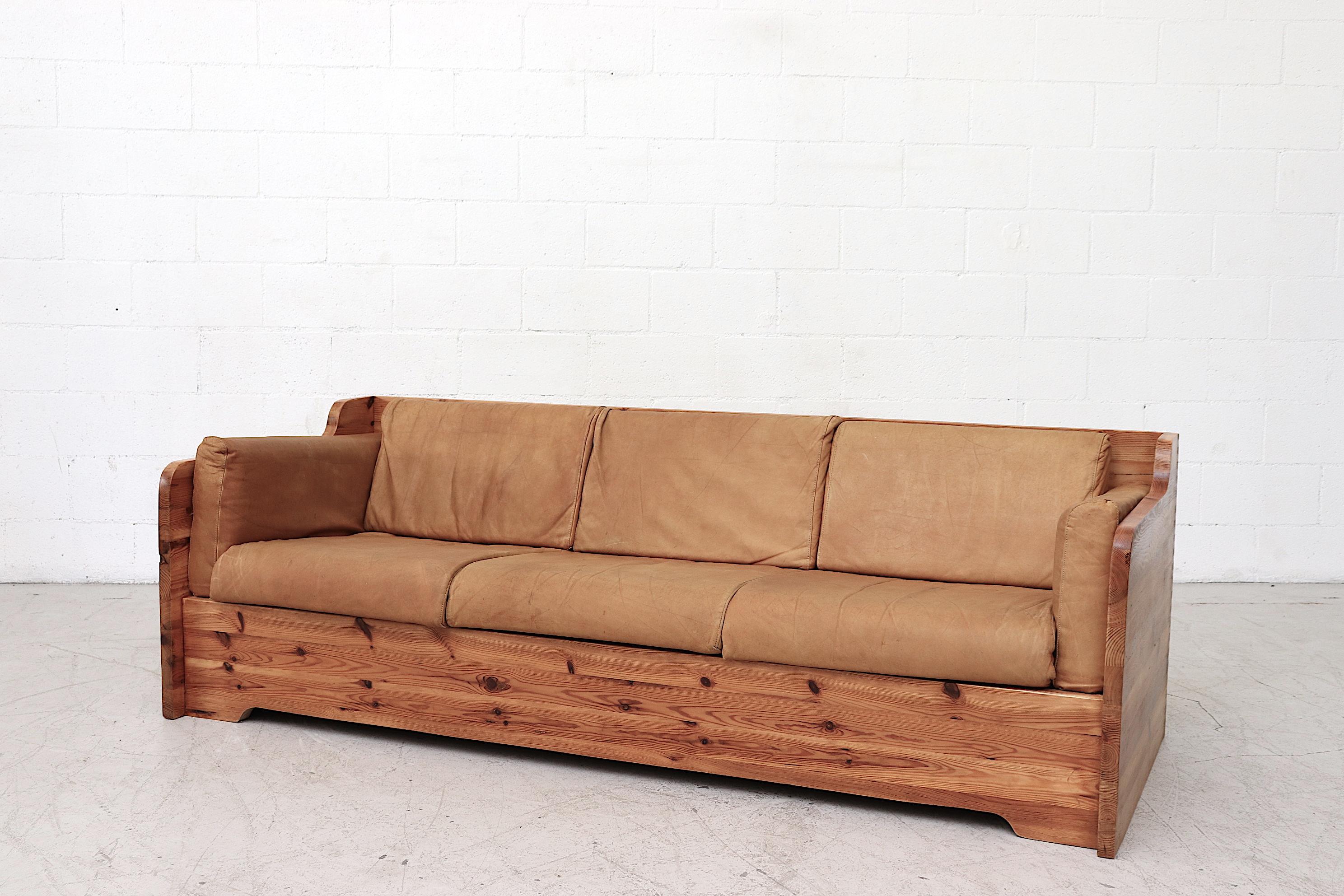 Gorgeous 3-seat sofa with natural leather cushions and solid pine crate frame. Frame and leather are in original condition with slat support. Visible wear with some fading and minimal scratching but overall good condition. Wear consistent with age