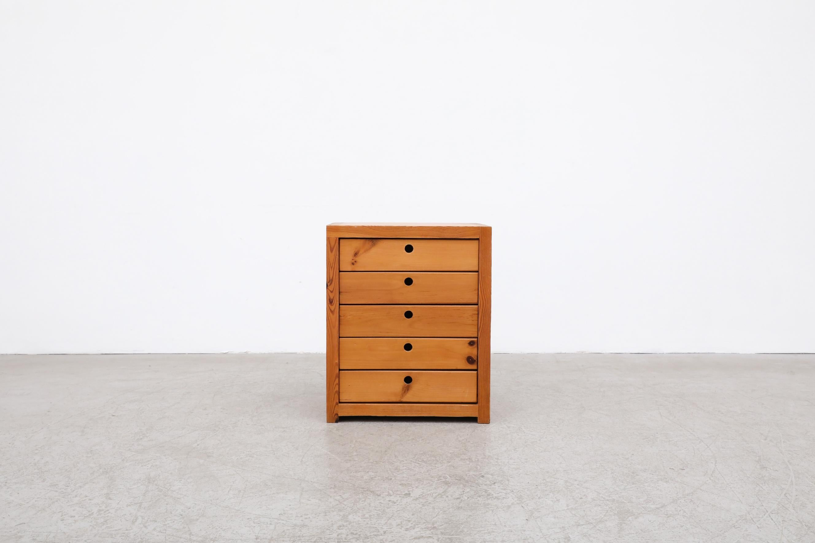 This small set of 5 stacked drawers is made from lightly solid pine and features hole cut-out drawer pulls. It's in original condition with a few minor scratches, no structural damage, the wear is consistent with its age and use. It can be used as a