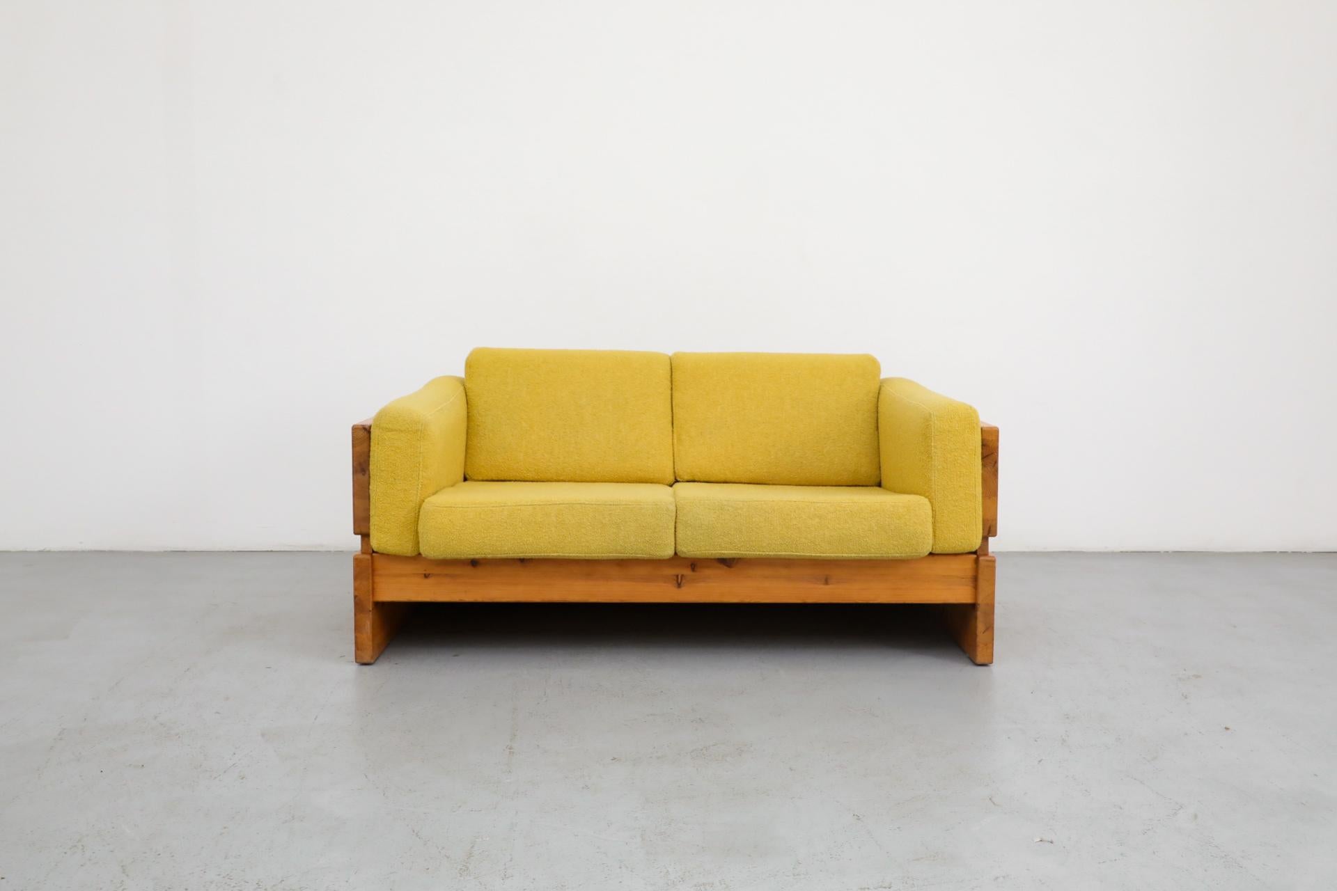 Ate van Apeldoorn style pine loveseat with upholstered yellow cushions. In otherwise good original condition with visible wear consistent with its age and use. Matching sofa with blue cushions also available, listed separately (LU922442636792).