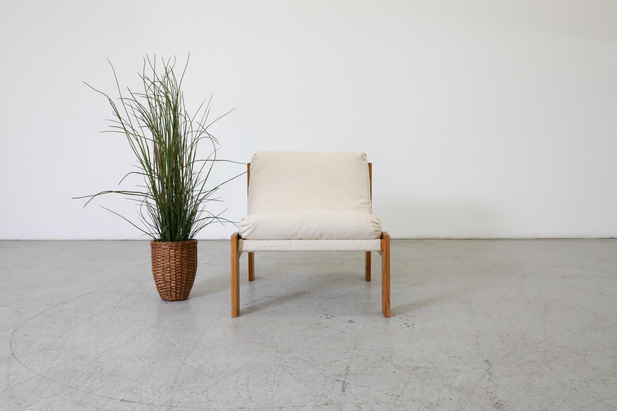 Mid-Century safari lounge chair with pine frame and natural canvas sling cushion. A comfortable side chair perfect for indoor or covered outdoor space with newly upholstered fabric. Frame is in original condition with visible wear consistent with