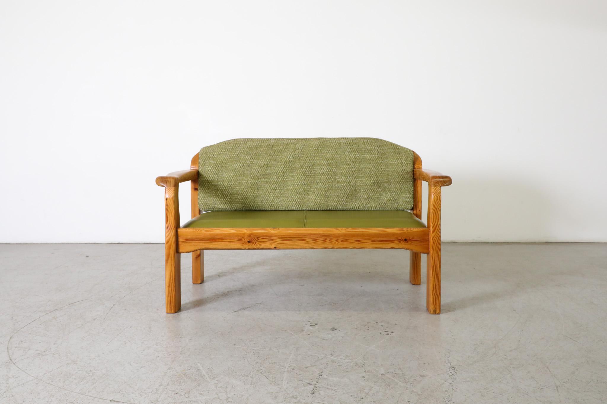 Mid-Century Ate van Apeldoorn style pine two seater bench with green skai seat and newly upholstered green fabric back cushion. Beautiful carved wood frame with attractive grain and round legs. In original condition with visible wear consistent with
