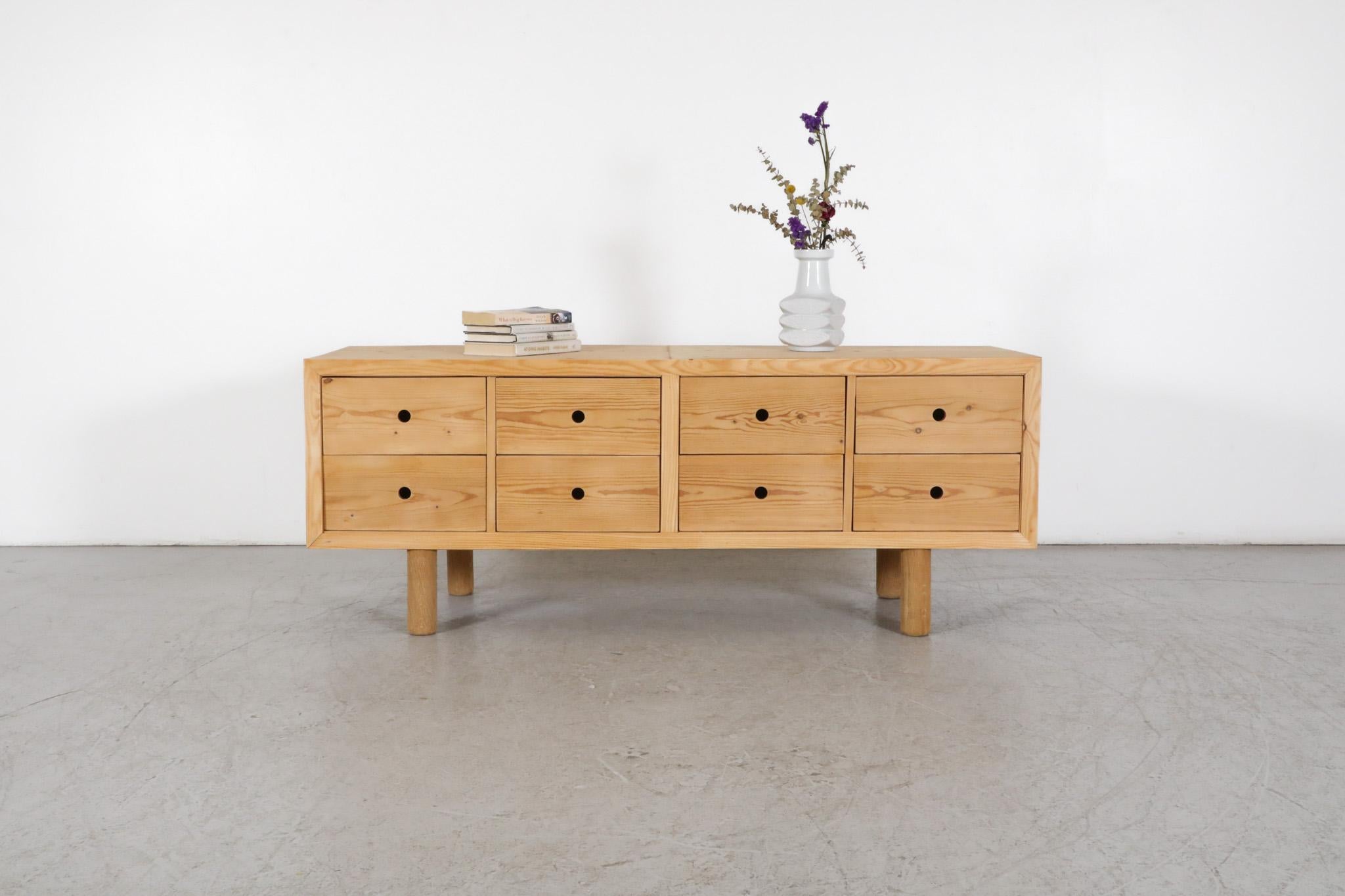 Mid-Century Danish pine credenza in the style of Ate Van Apeldoorn. Natural wood frame containing eight storage drawers with cut-out finger pulls. Lightly refinished, in otherwise original condition with age appropriate wear consistent with regular