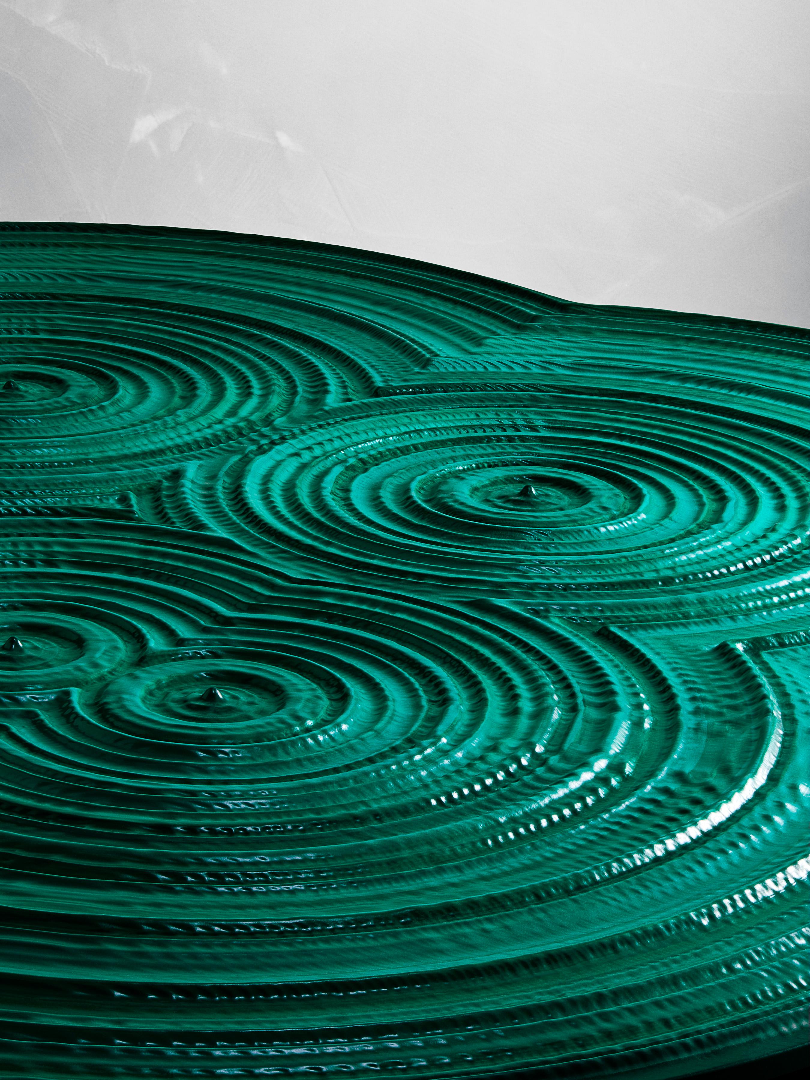 The Malachite Low Table is the perfect accent with hand carved, stained ash wood, and resin. It is a theoretical amalgamation of organic and inorganic, the flowing concentric malachite rings allude to the natural growth of trees.  This table so far