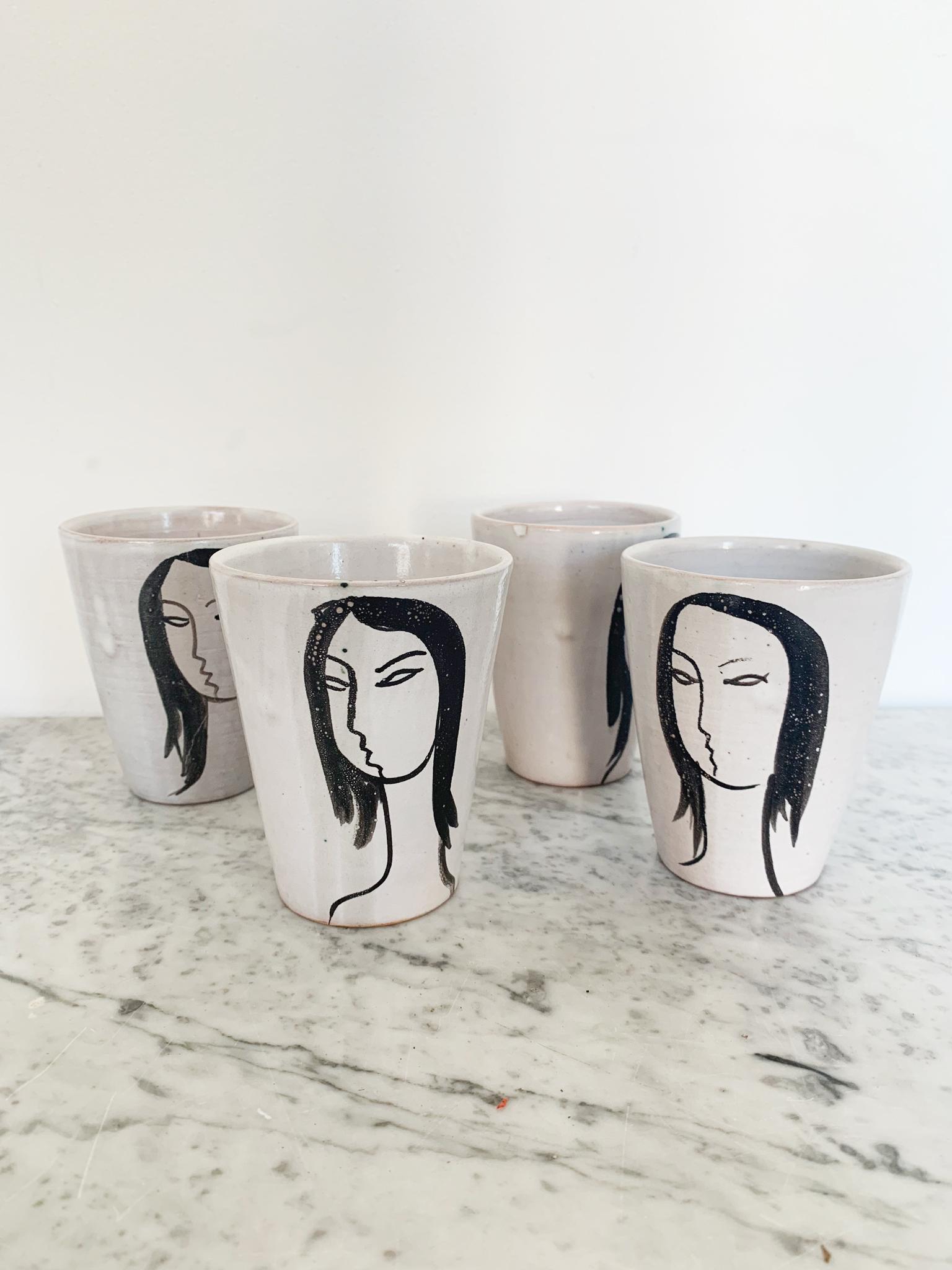 Set of four cups in a white glaze, these pots are skilfully decorated with a profile drawing of a woman. Stamped and Monogrammed Vallauris and Grand Chene pottery.

Grand Chene (Big Oak) pottery was founded in 1949 by Odette Gourju and Ljuba