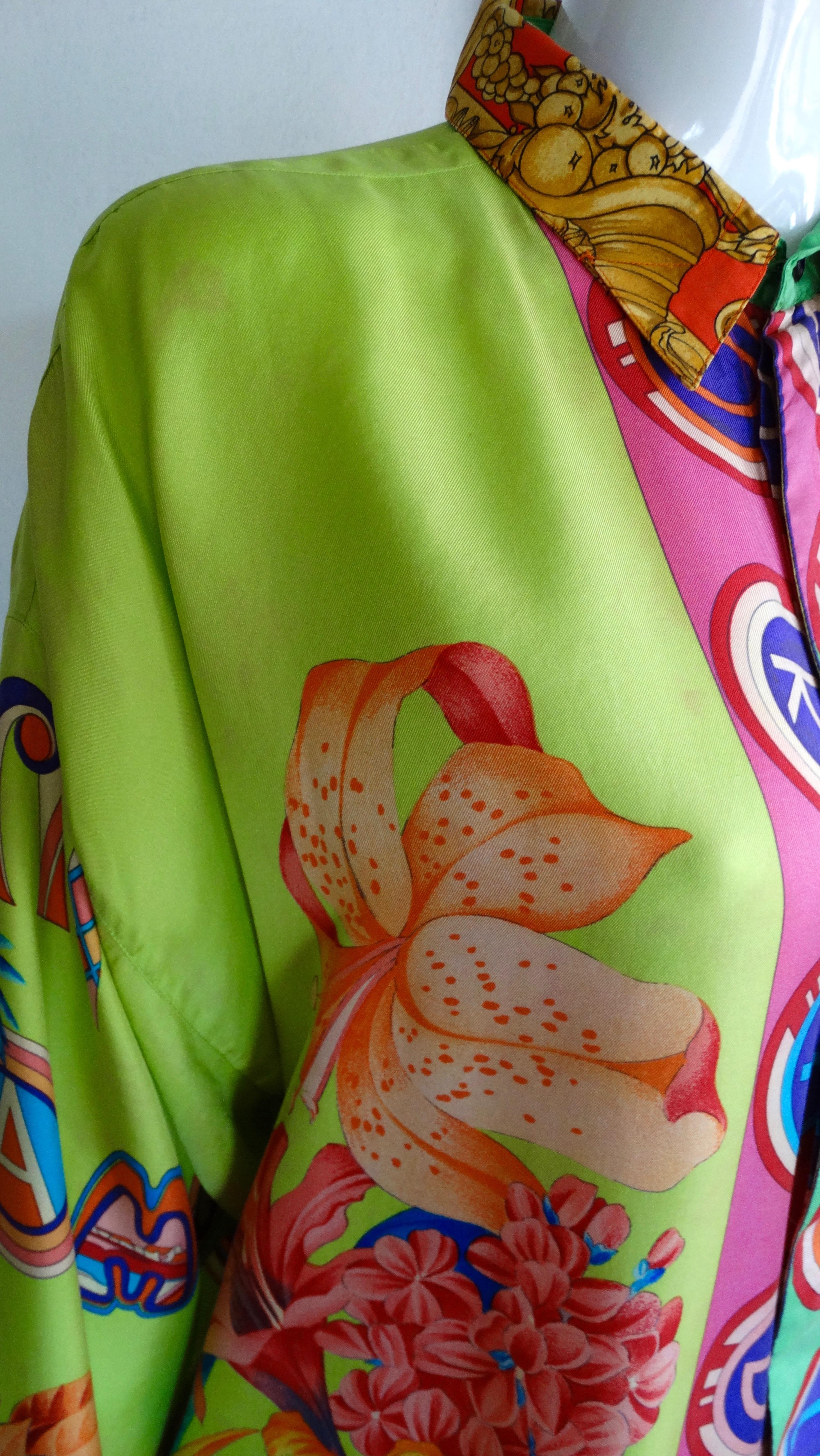Gianna Versace straight from the Versace archives! Circa 1990s, this silk shirt features a Miami inspired print with bright neon colors, various tropicana floral arrangements, and decorative fonts spelling out 