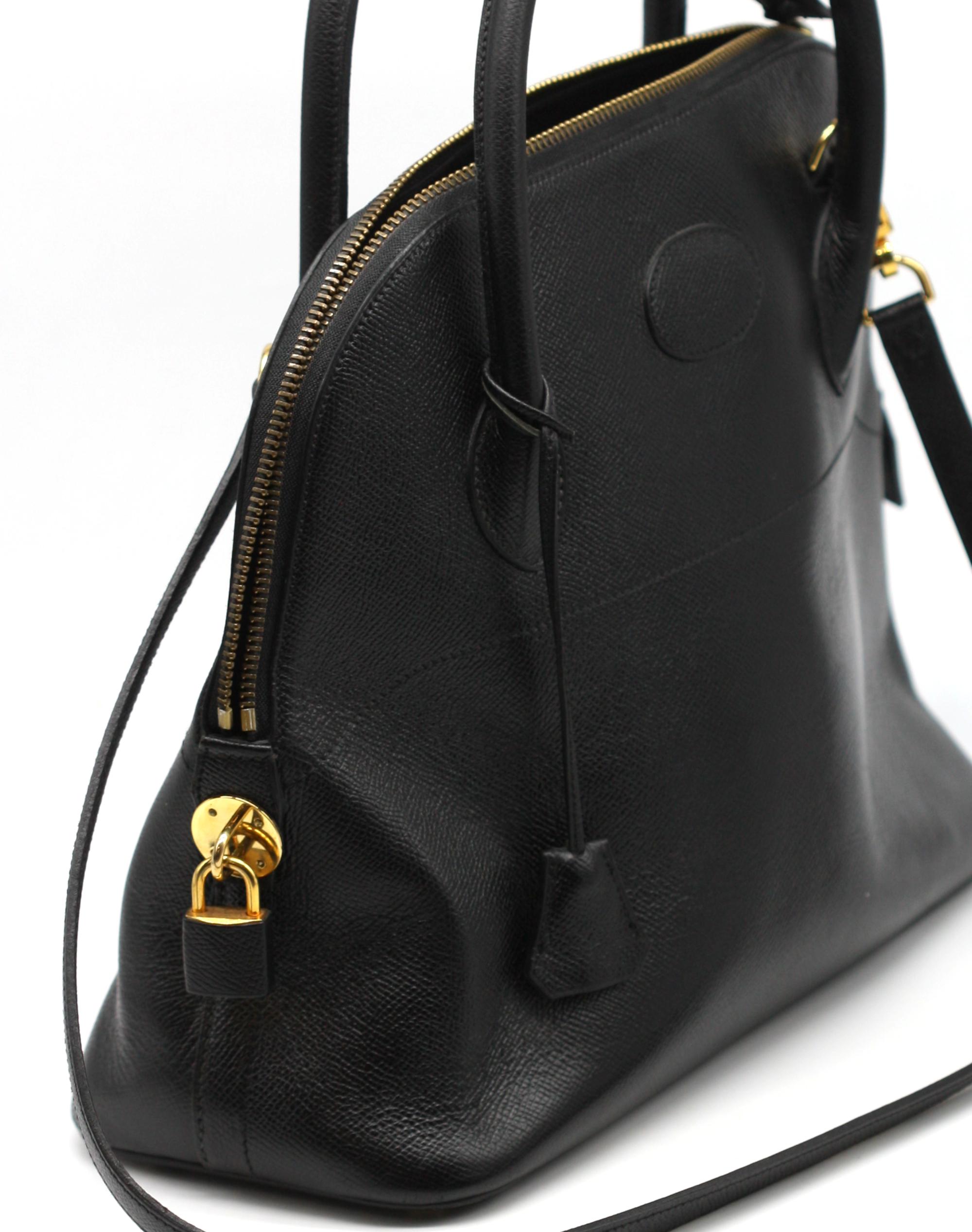 
Atelier J.P. Renard Black Leather Bolide Type Handbag
with double rolled loop handles, gold-toned hardware, with an interior zipper pocket and a slit pocket, with a leather shoulder strap, lock and two keys..
Height, including handles, 13.5 in.,