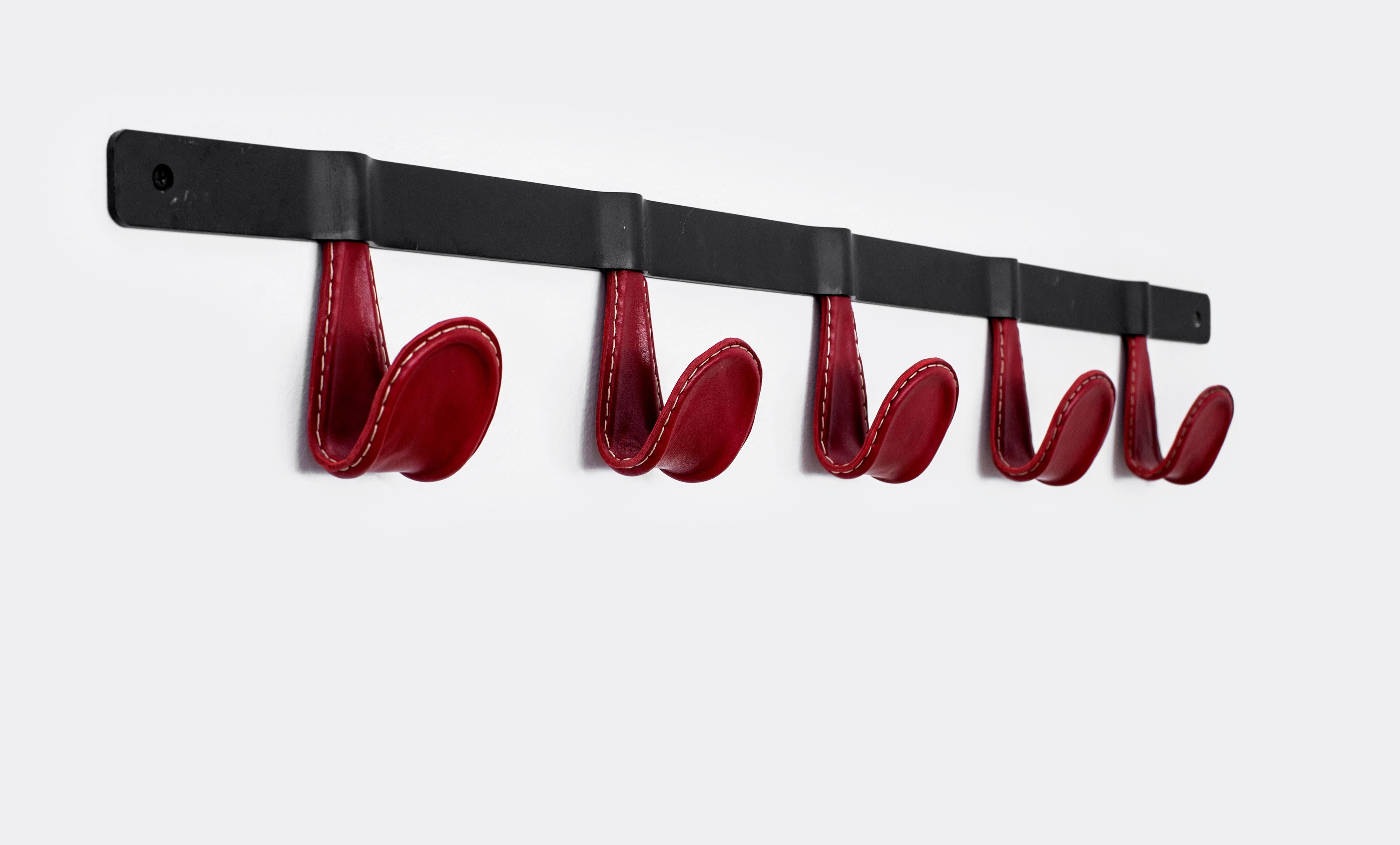 Beautiful five hook iron and leather wrapped coat rack. Each hook covered in red leather with white contrast stitching. Newly produced by Orange furniture, multiple quantities and other colors available.