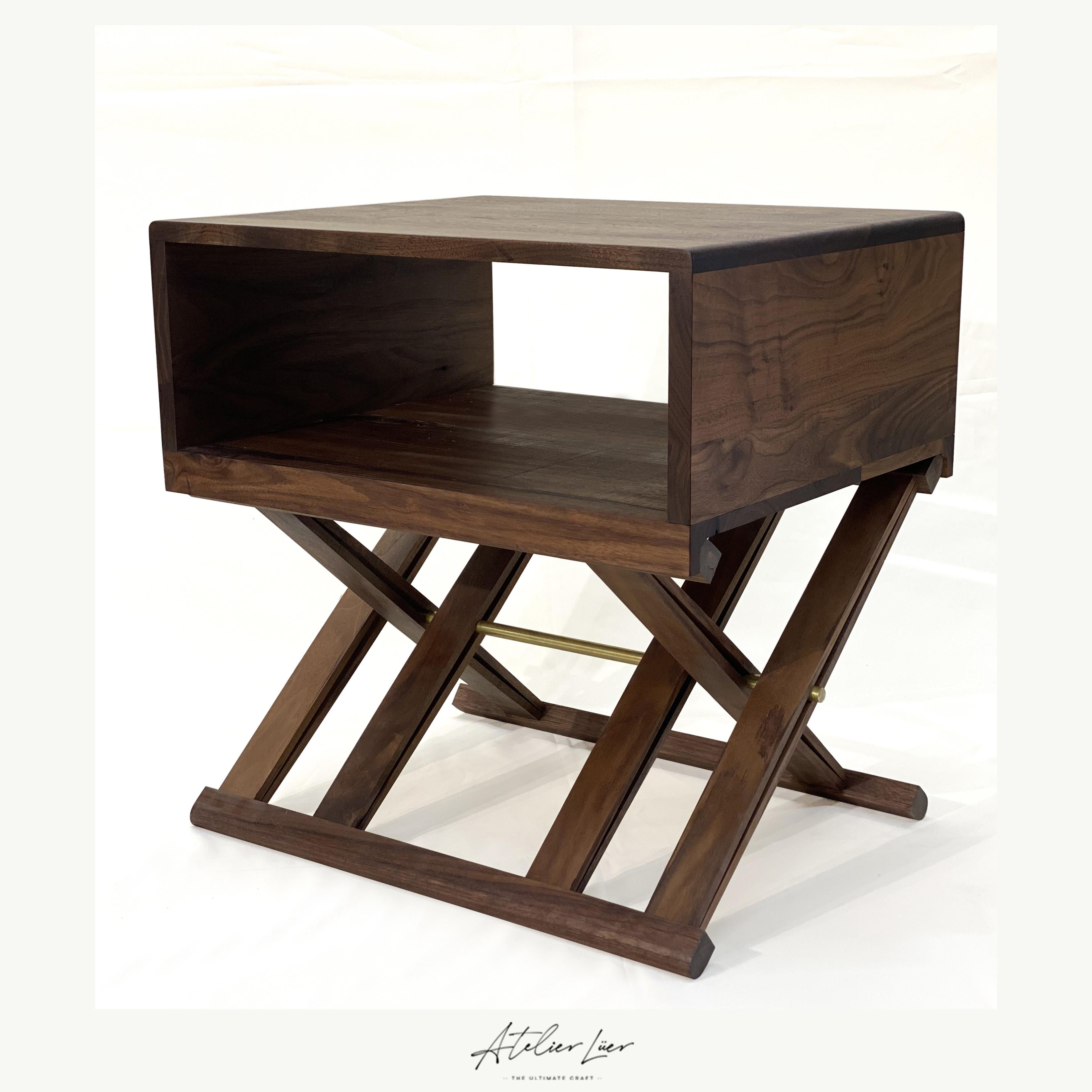 Atelier Luer open shelf solid walnut night/end table with X-Frame Base & Brass

Offered for sale is an Atelier Luer open shelf solid walnut night/side/end table with an x-frame base with brass hardware, leather straps with collapsible base and