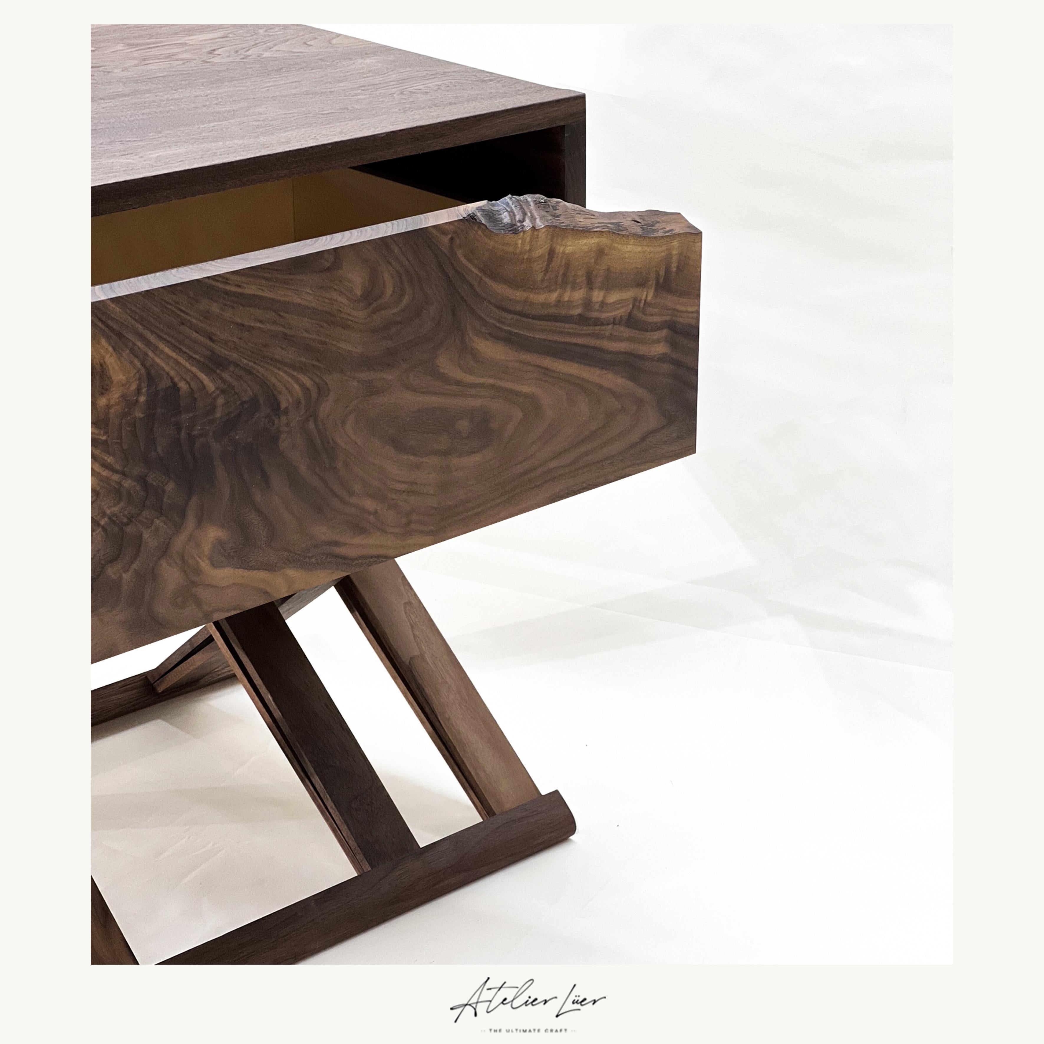 Atelier Luer walnut nightstand/end table with live edge drawer & x-frame base

Offered for sale is an Atelier Luer solid walnut nightstand/end/side table with a live edge drawer and an x-frame base with brass hardware and leather straps. This