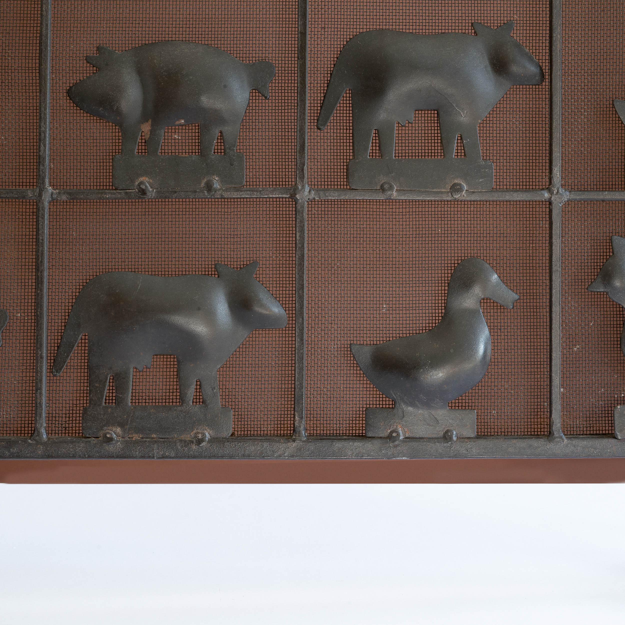 Atelier Marolles wrought iron fire guard, French, 1950-1960s, with farm animals, backed with wire mesh.