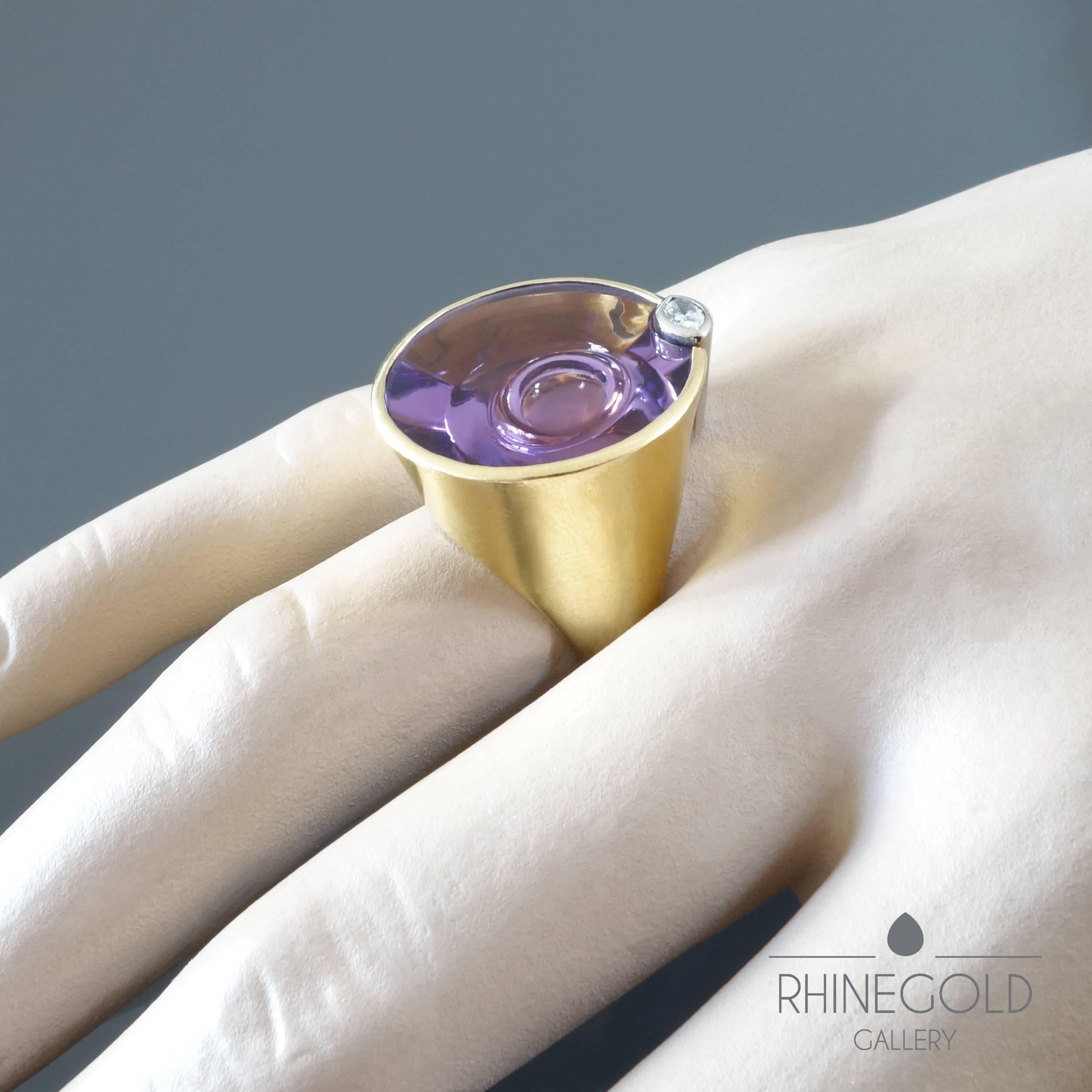 Atelier Munsteiner Amethyst Diamond Yellow and White Gold Cocktail Ring 
18k white and yellow gold, amethyst (approx. 22 ct.), diamond (G, vs, approx. 0.1 ct.)
Ring head 2.15 by 2.25 cm (approx. 13/16” by 7/8”)
Ring size: Ø 17.7 mm = EU 55.7 / US