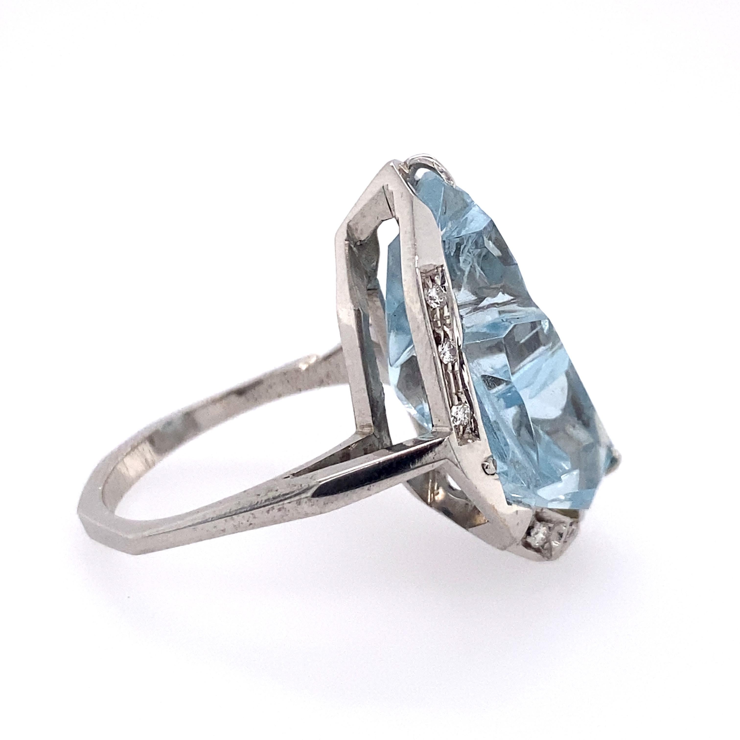 18k gold ring with fancy designer Atelier Munsteiner aquamarine (measuring approx. 23 x 12.85 x 10mm) with approx. 0.10ctw in diamonds. Ring size - 8.5, ring top - 27mm x 18mm. Weight - 11.7 grams 7.52 dwt