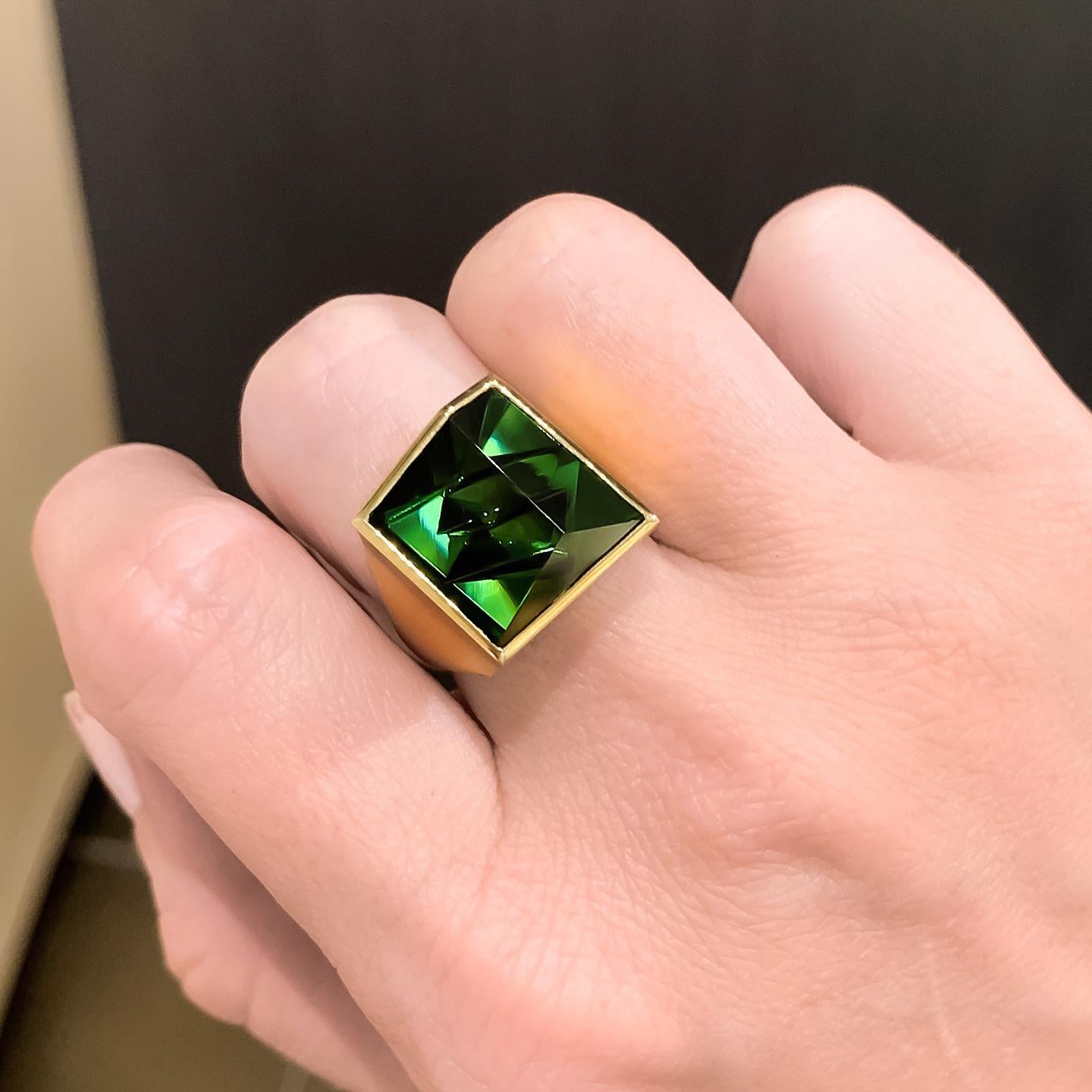 One-of-a-Kind Ring handcrafted in Germany by Atelier Munsteiner showcasing a top quality, hand-cut 10.87 carat deep green tourmaline in satin-finished 18k yellow gold. Size 7.0 (can be sized). Stamped and Hallmarked.

About the Artist - Atelier