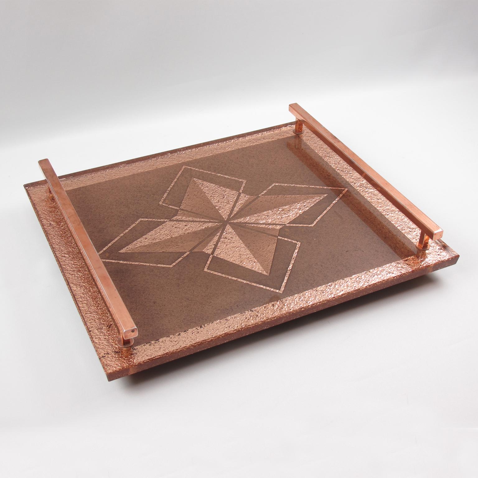 This lovely French Art Deco copper metal and peach-color mirror tray features a thick mirrored glass slab in copper or pink-peach color with reverse geometric etching and star design. The tray has large copper handles on both sides. The delicate and