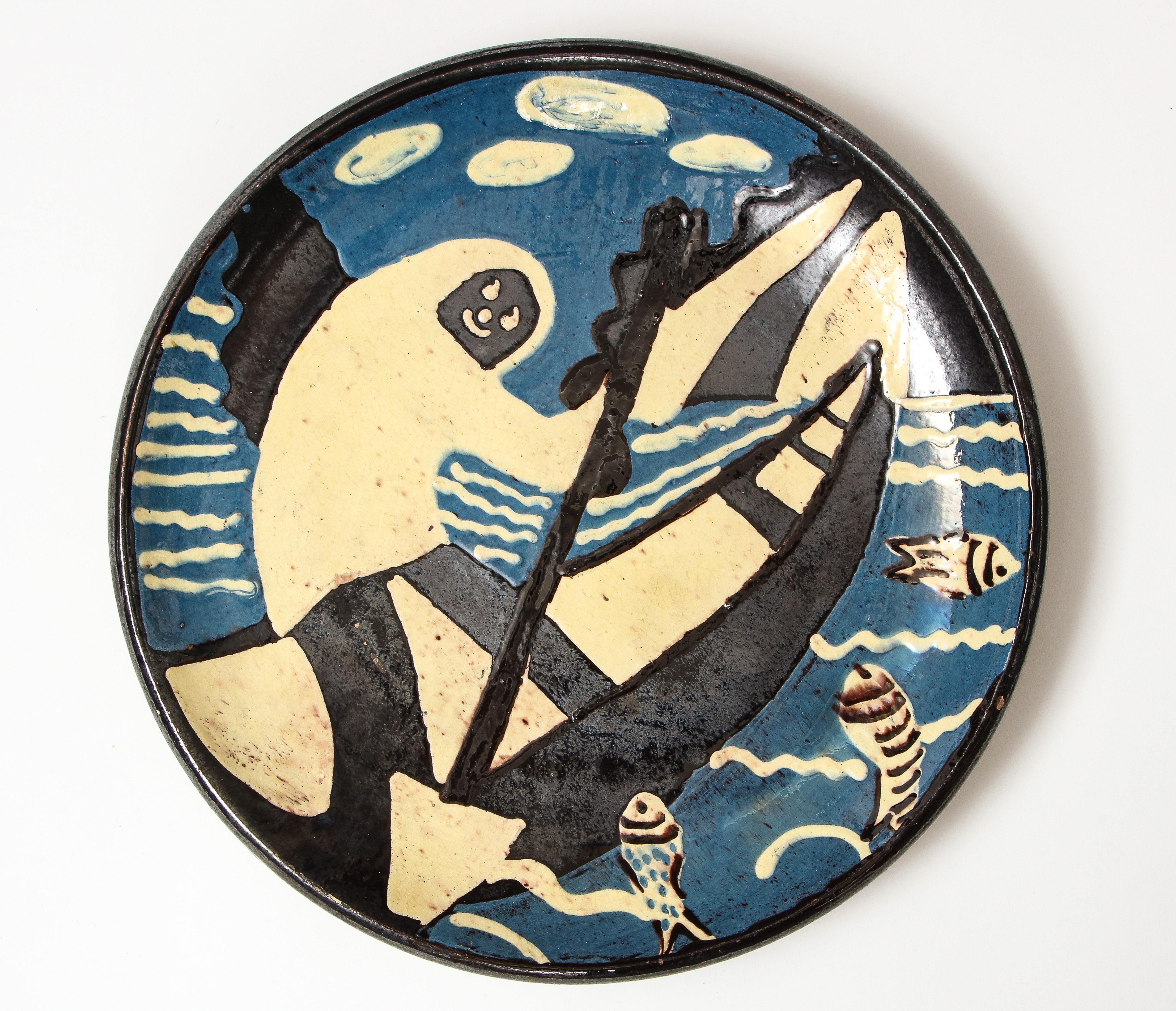 Atelier Primavera ceramic platter depicting smiling rower in canoe, France, early 20th century.