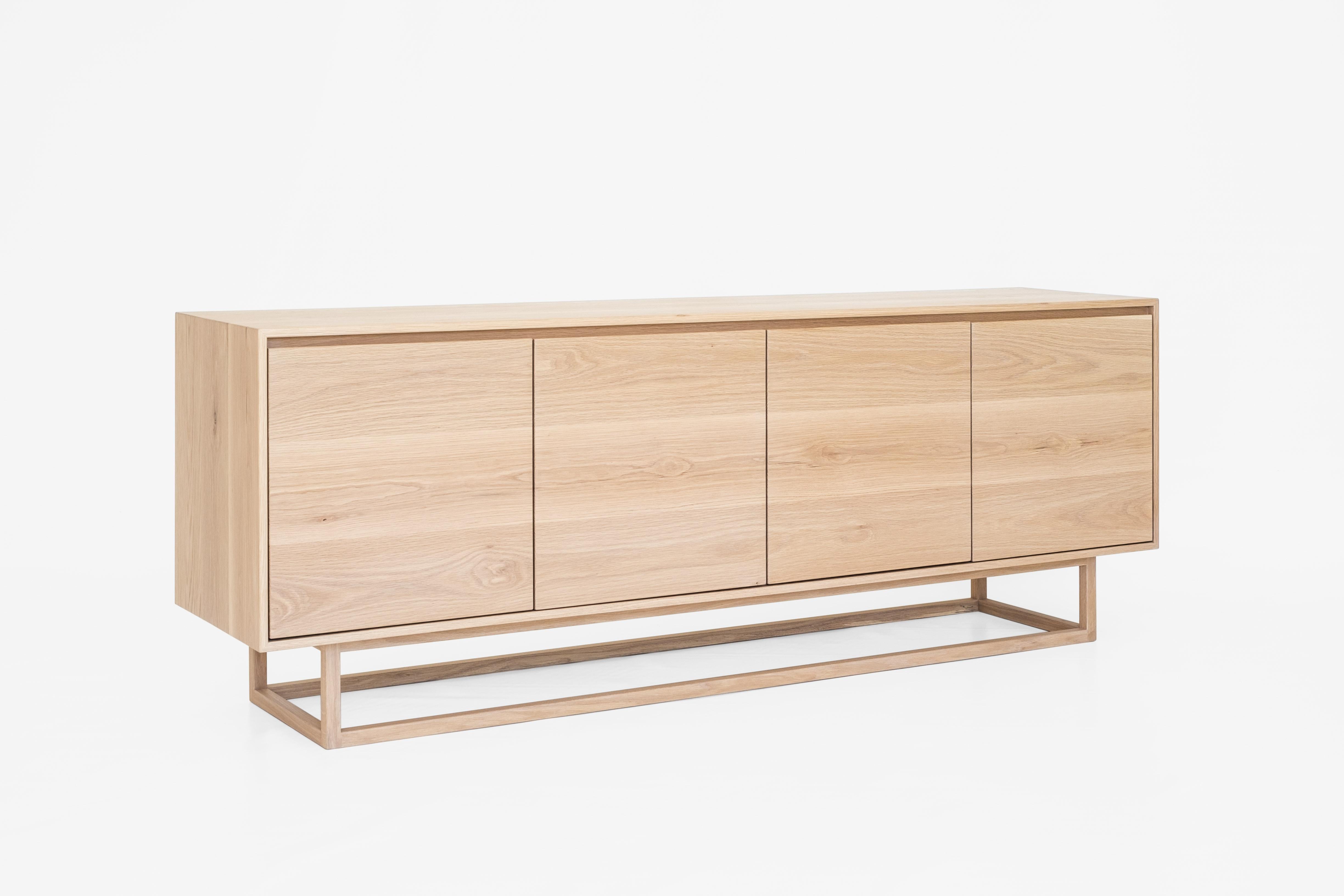 The Mr and Mrs White Atelier sideboard is a beautiful storage solution. A minimalist style, pictured here featuring a solid American white oak unit sitting on a box style frame. The continuous grain detail on the cupboard doors makes each sideboard