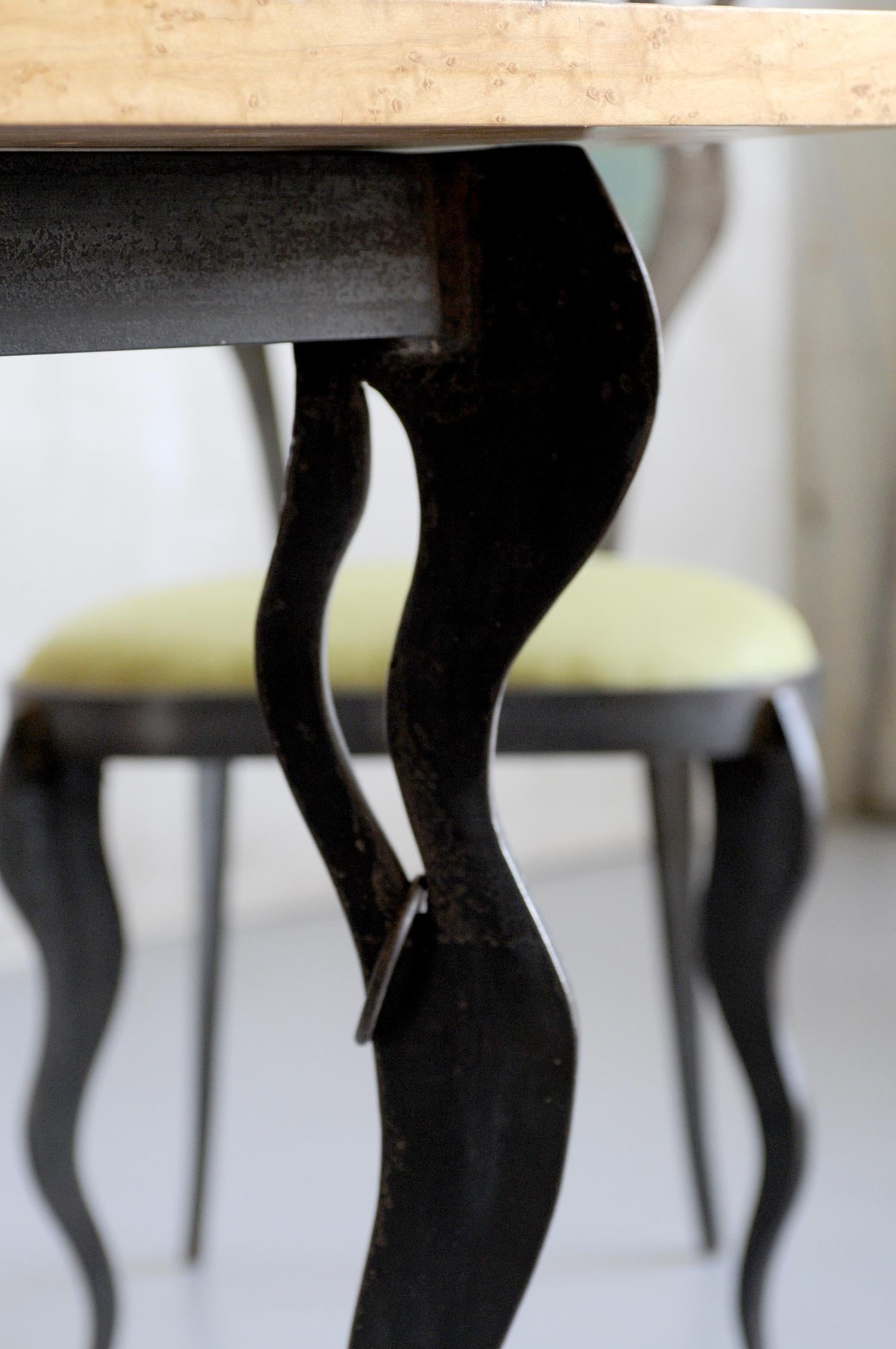 Atelier S.L Prestige, Biot, France 2012. Set composed of a wrought iron and patinated iron table, chapped and speckled maple top accompanied by its two chairs. The thick iron bases are lively and perforated, 4 rings adorn the table. Unique pieces,