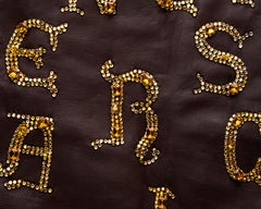 Atelier Versace brown leather skirt with gold crystal calligraphy, fw 1997