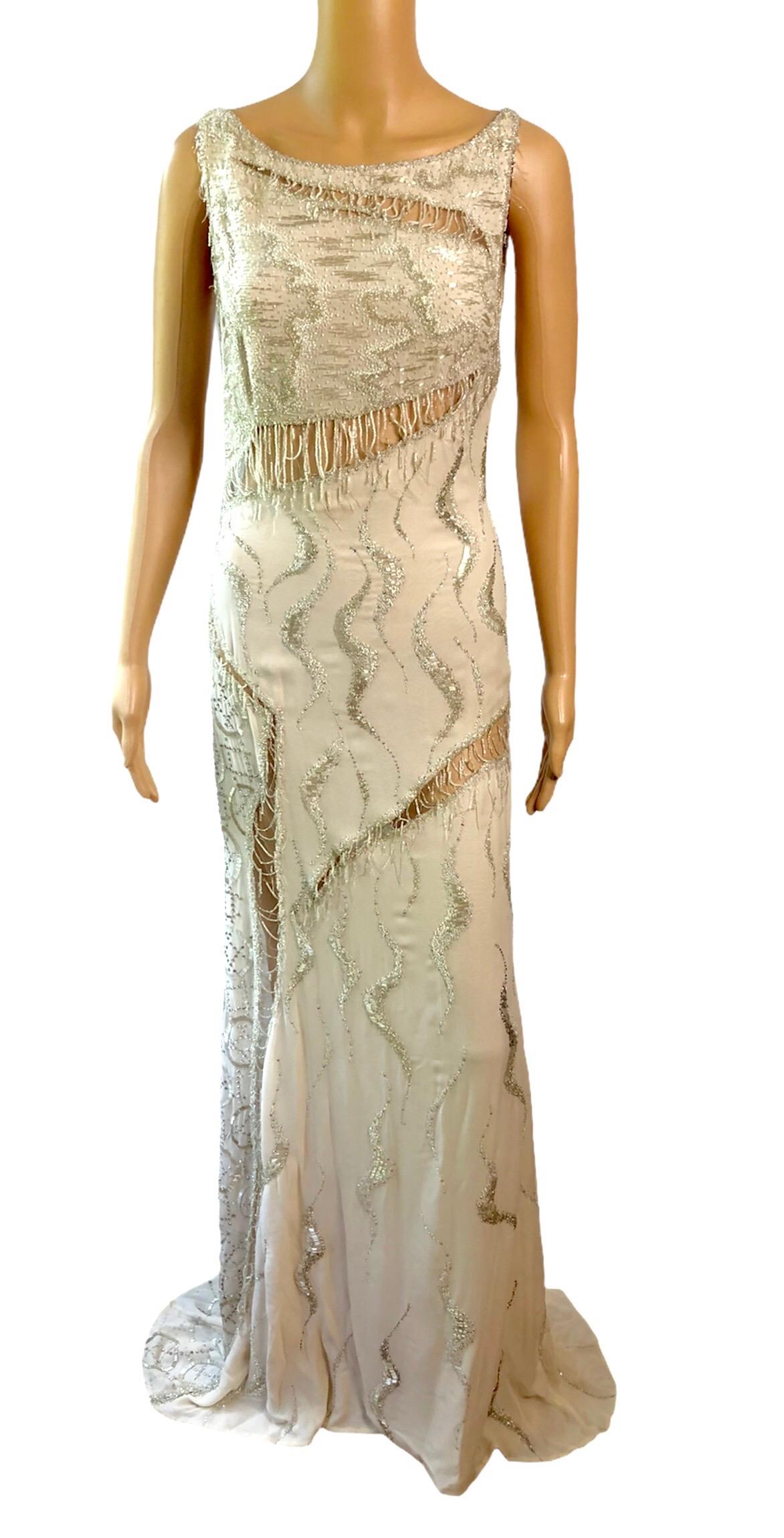 Atelier Versace Couture F/W 1998 Runway Embellished Sheer Cutout Gown Evening Dress IT 42

Seen on F/W 1998 Haute Couture Runway. Atelier Versace sleeveless maxi dress featuring bead and rhinestone embellishments, sheer cutouts, train at hem, and