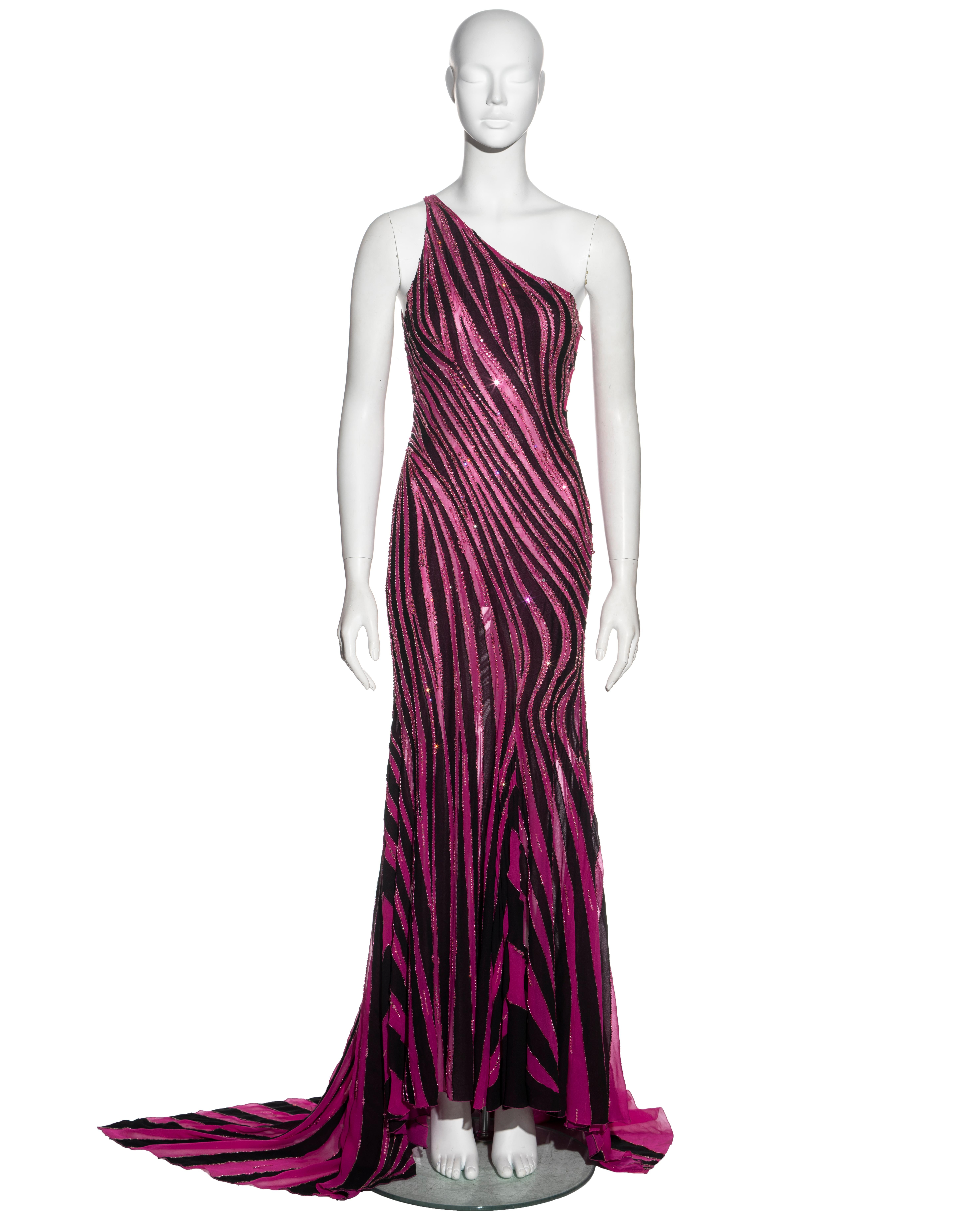 ▪ Atelier Versace couture evening dress
▪ Designed by Donatella Versace
▪ Constructed from multiple strips of pink and black silk in a vertically striped pattern resembling a zebra print
▪ Embellished with thousands of hand-sewn crystals outlining