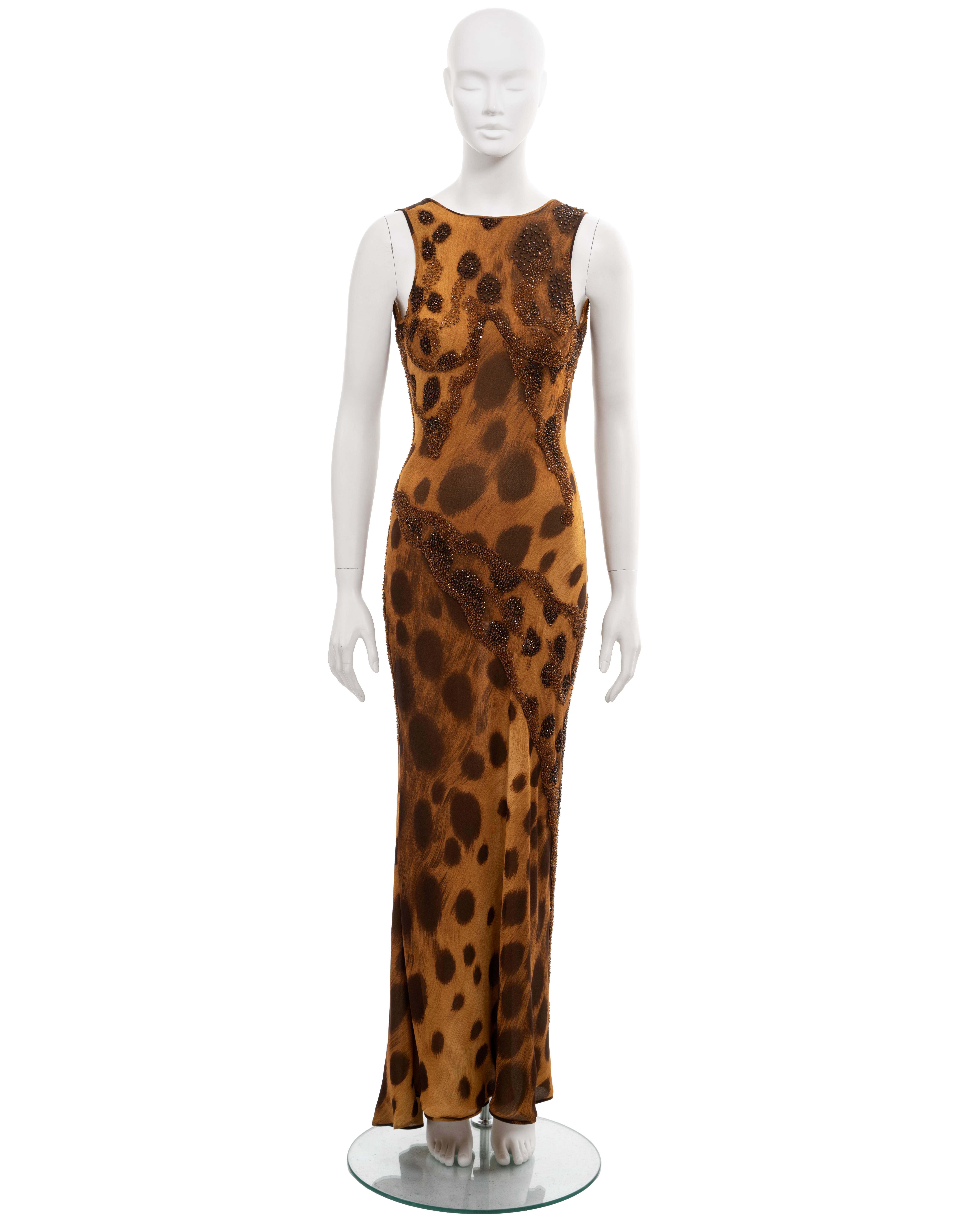▪ Archival Atelier Versace evening dress
▪ Haute Couture, Fall-Winter 1996 
▪ Sold by One of a Kind Archive
▪ Museum Grade
▪ Constructed from a cheetah-printed silk, featuring warm tones of tan, brown, and black
▪ Thousands of hand-sewn faceted
