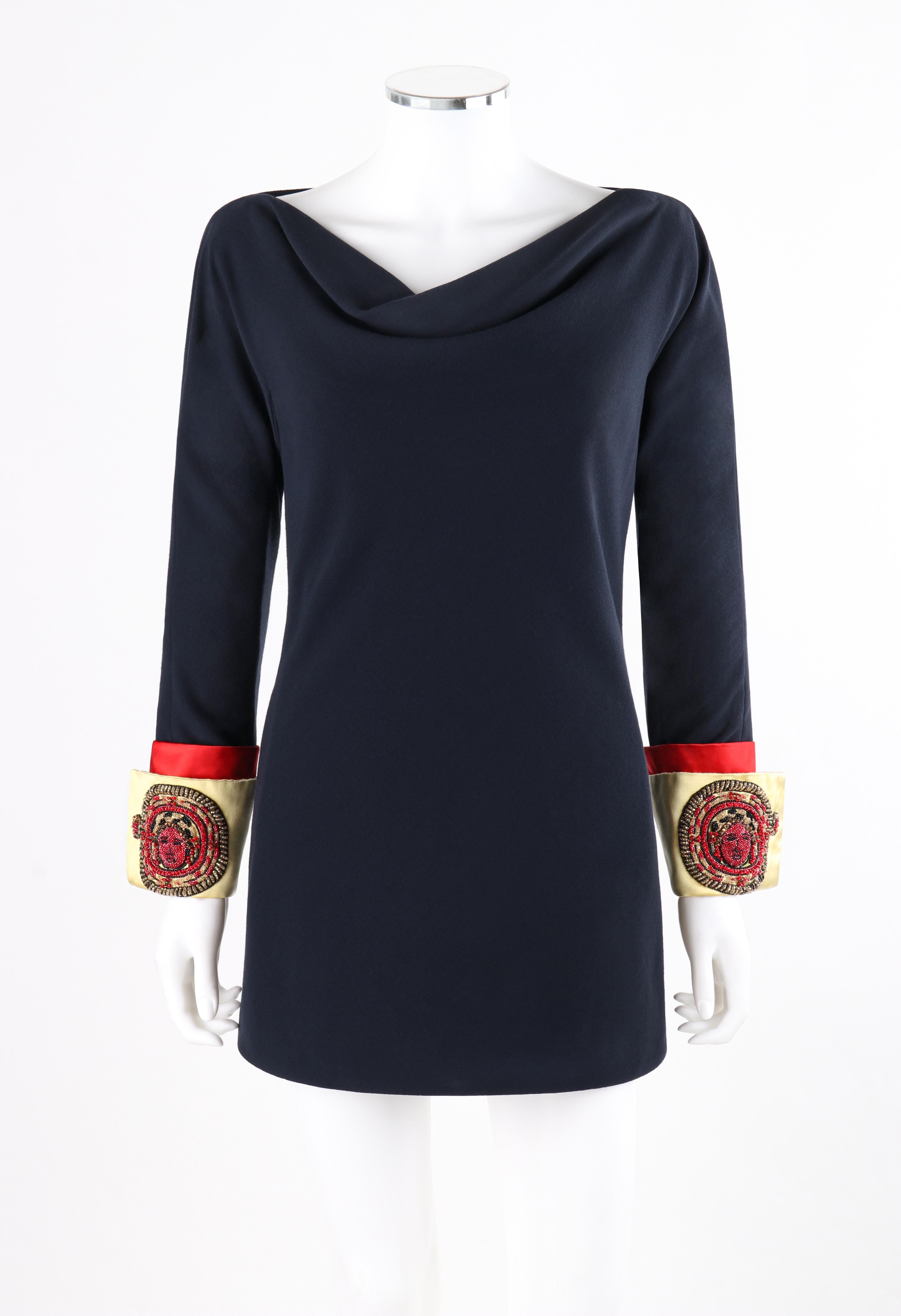ATELIER VERSACE S/S 1990 Mini Navy Embellished Medusa Cuff Sleeve Tunic Dress

Brand / Manufacturer: Atelier Versace
Collection: S/S 1990
Designer: Gianni Versace
Style: Mini tunic dress with cowl neckline. 
Color(s): Shades of blue, red, yellow and