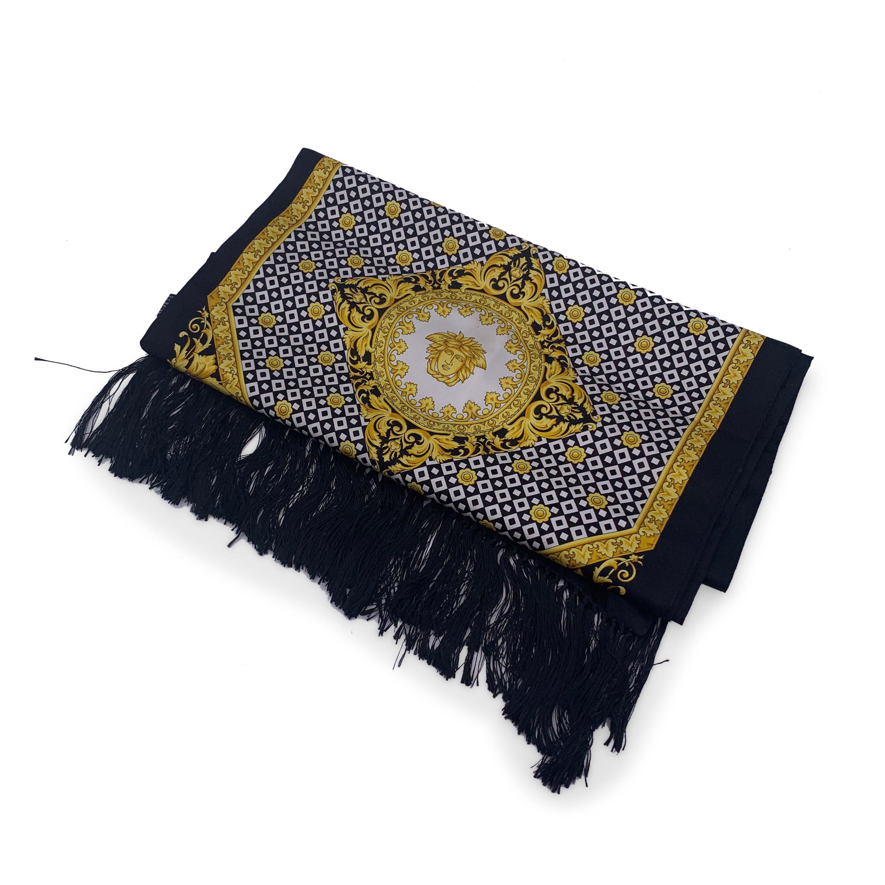 Beautiful Atelier Versace vintage silk shawl in black gold and black colors. Souble-sided: a side is in pure silk with baroque Medusa print and the other side is pure wool in black color. Fringed borders. Measurements: 17.5 - 62 inches - 44.5 cm x