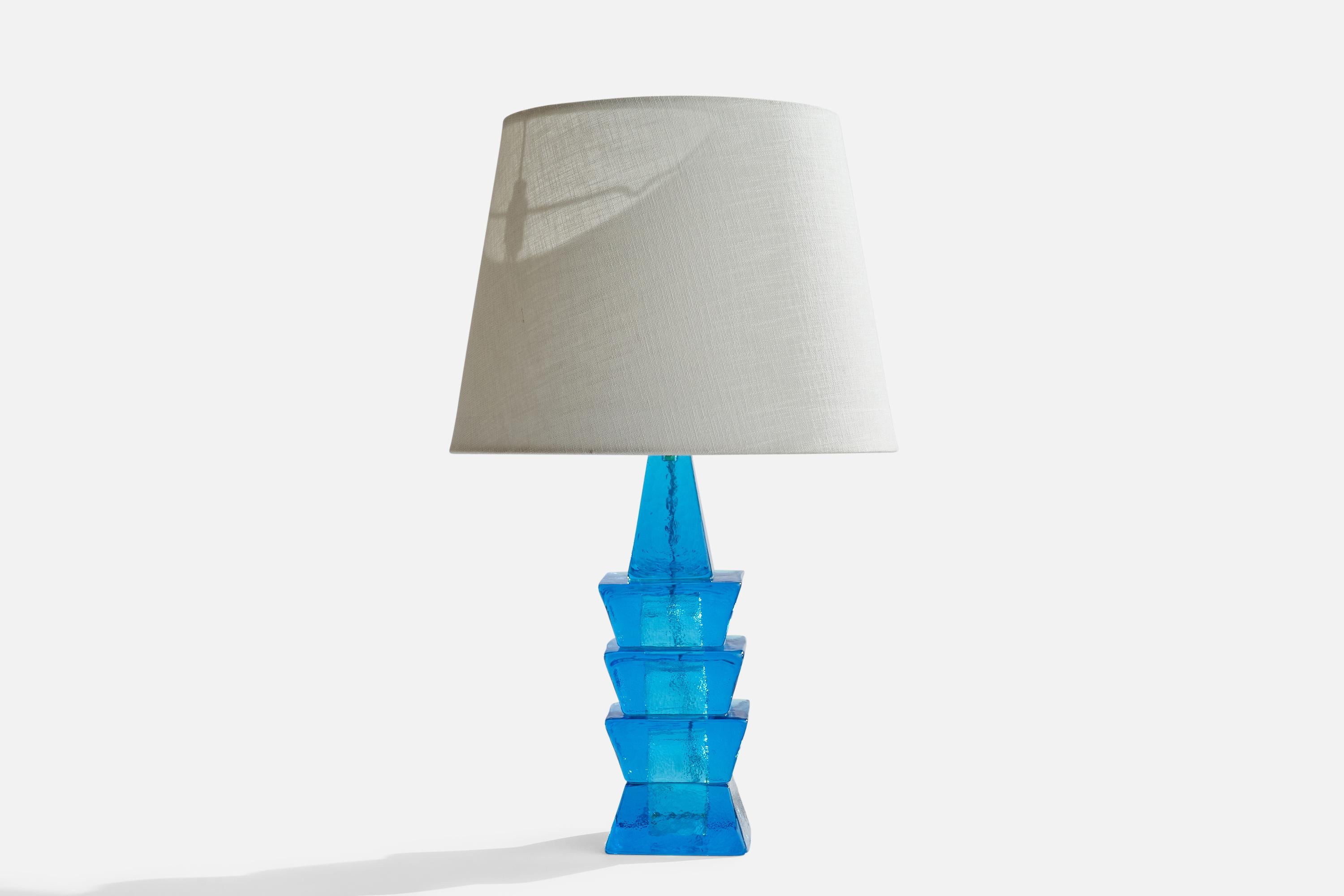 A blue-coloured glass table lamp designed and produced by Ateljé Engberg, Urshult, Sweden, c. 1970s.

Dimensions of Lamp (inches): 14” H x 3.75” Diameter
Dimensions of Shade (inches): 9” Top Diameter x 12”  Bottom Diameter x 9.25” H
Dimensions of