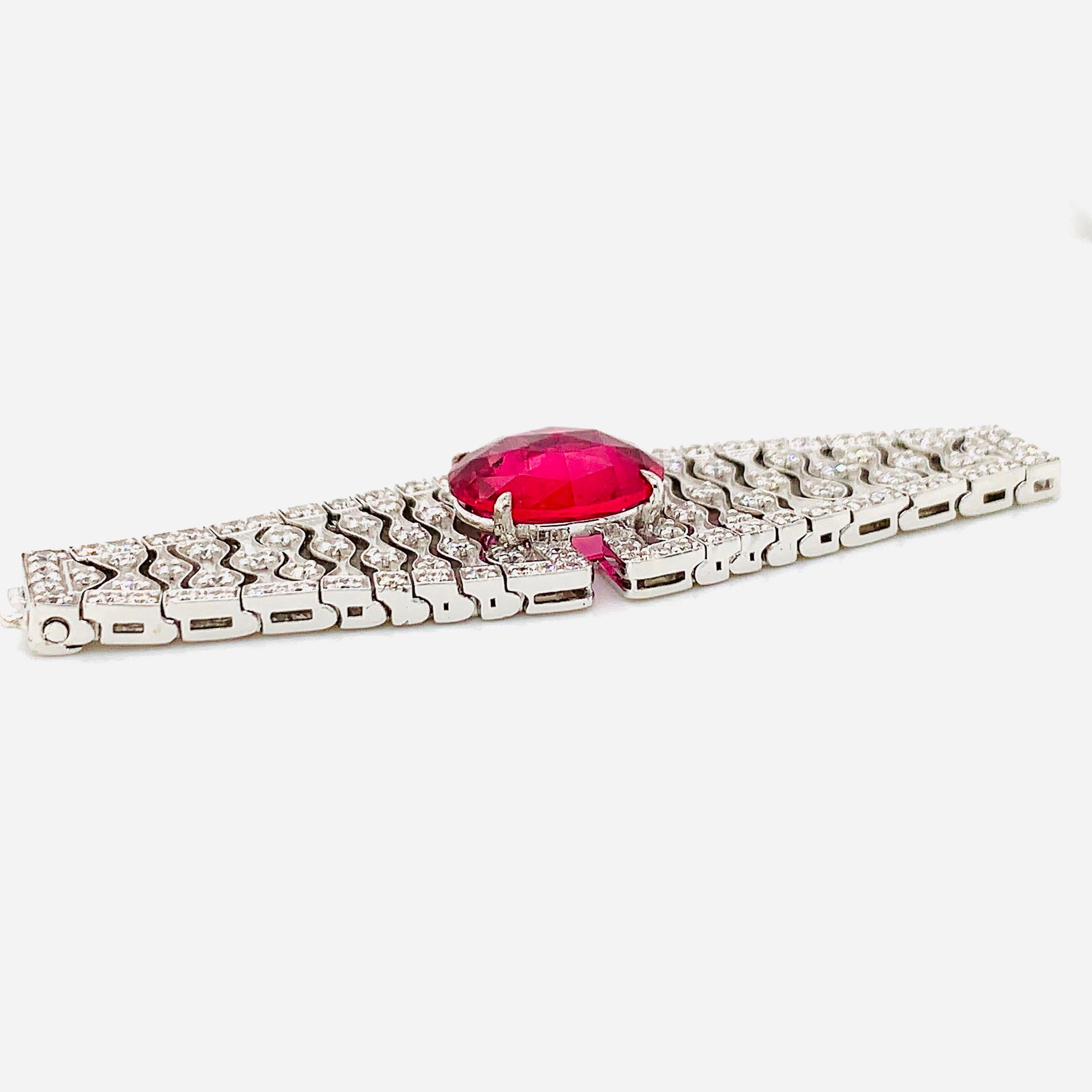 A magnificent jewel consisting of a stunning deep-red tourmaline and hand-set diamonds in 18 karat white gold. This piece can be worn as both a ring and bracelet.

The entire piece with, including the 18 karat white gold mesh chain, wraps