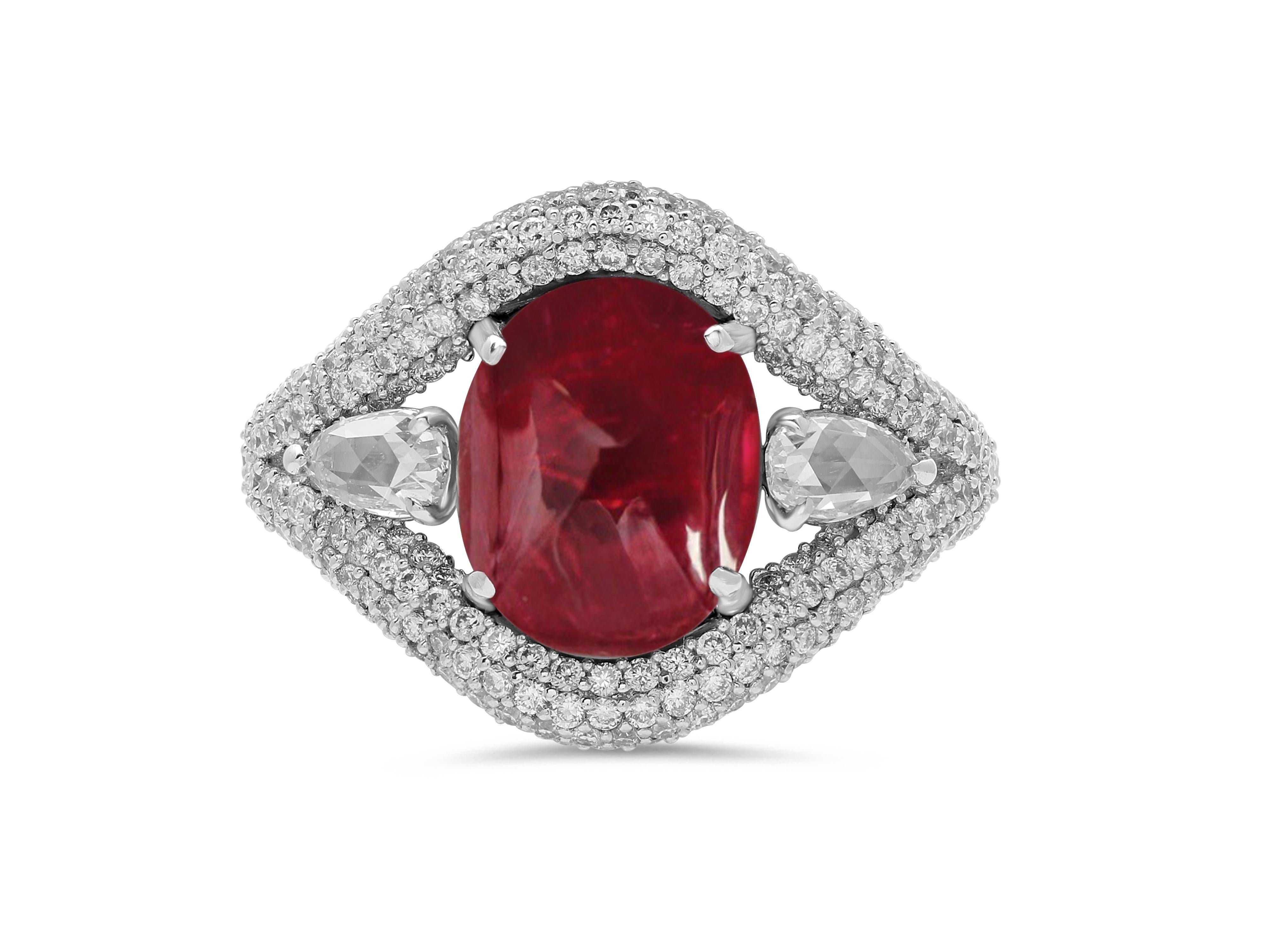 A stunning 3.52 carat round, rubellite cabochon forms the heart of this ring, surrounded by a carpet of handset diamonds.

The fluid lines of the design provide a perfect base for the micro-pave setting, creating a distinctive yet elegant