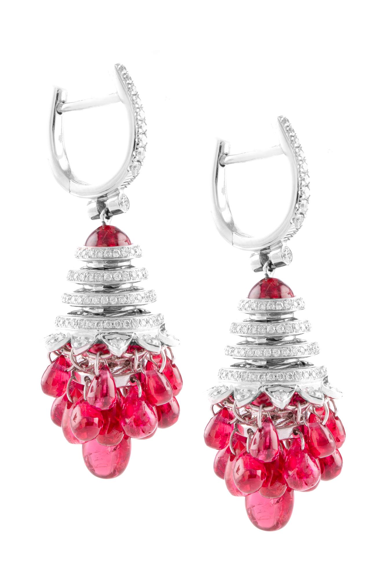 42 individually set spinel beads are carefully and expertly set below a spiral diamond setting in these stunning, hand-crafted earrings in 18 karat white gold.

Each spinel bead moves individually, resulting in a fluid design that sways with every