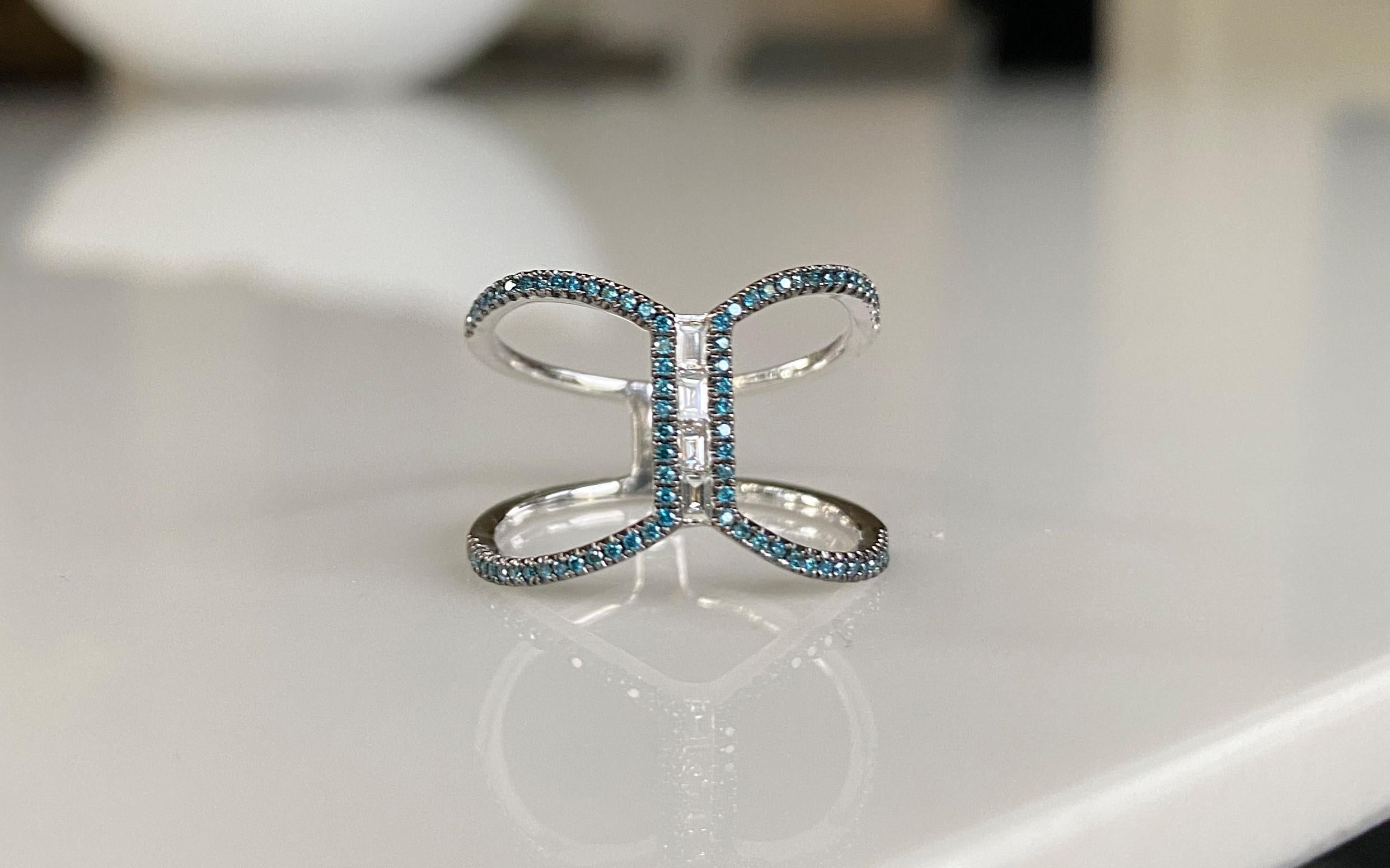 Make a statement with this exquisite ring with pave blue diamonds and generously sized white diamond baguettes. Dress up or down, wear it as a cordial ring or alternative bridal ring.  