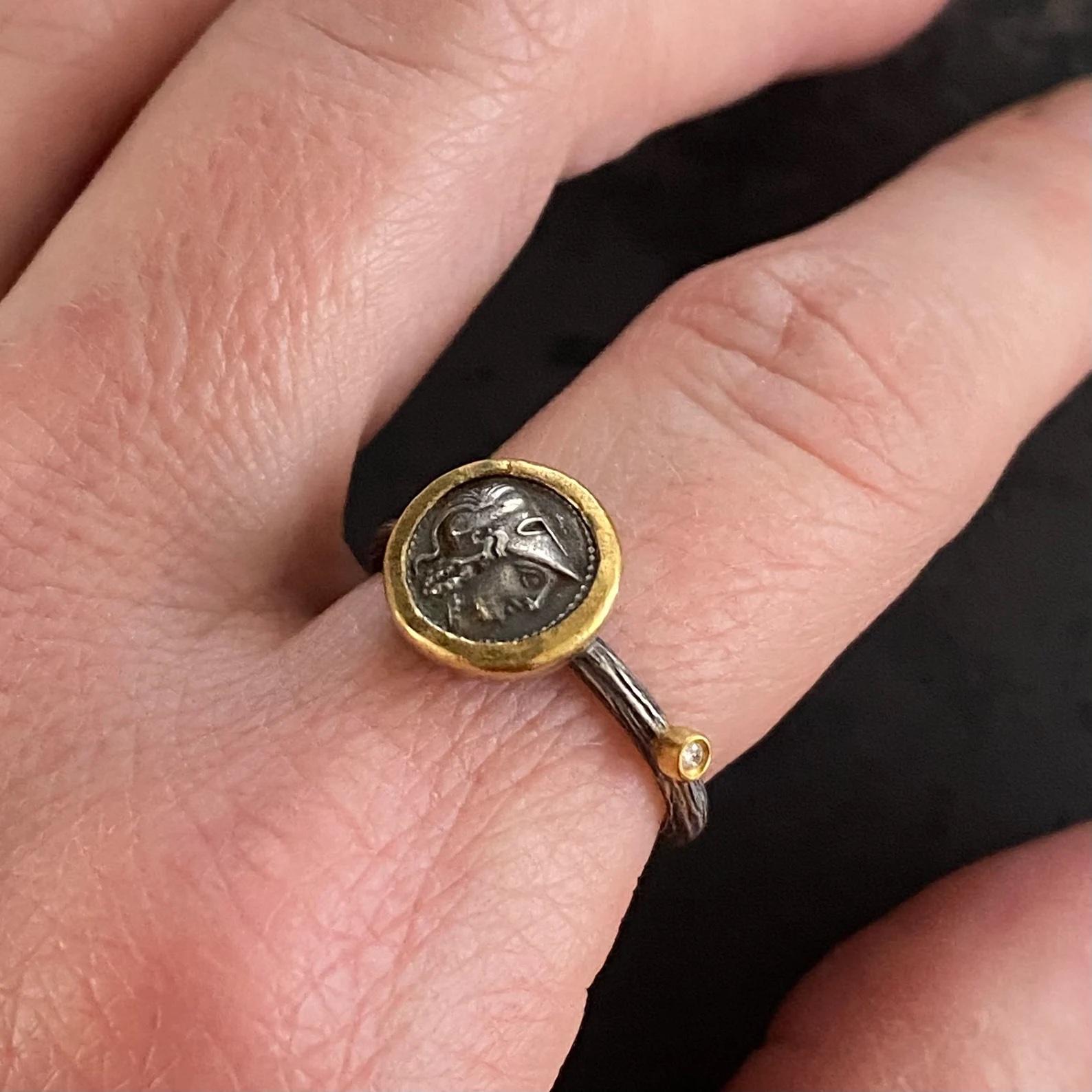 Athena Coin Ring with Single Diamond, Goddess of Wisdom and War, 24K Gold & SS, Size 6 1/2 
Athena is the Olympian goddess of wisdom and war and the adored patroness of the city of Athens. A virgin deity, she was also – somewhat paradoxically –