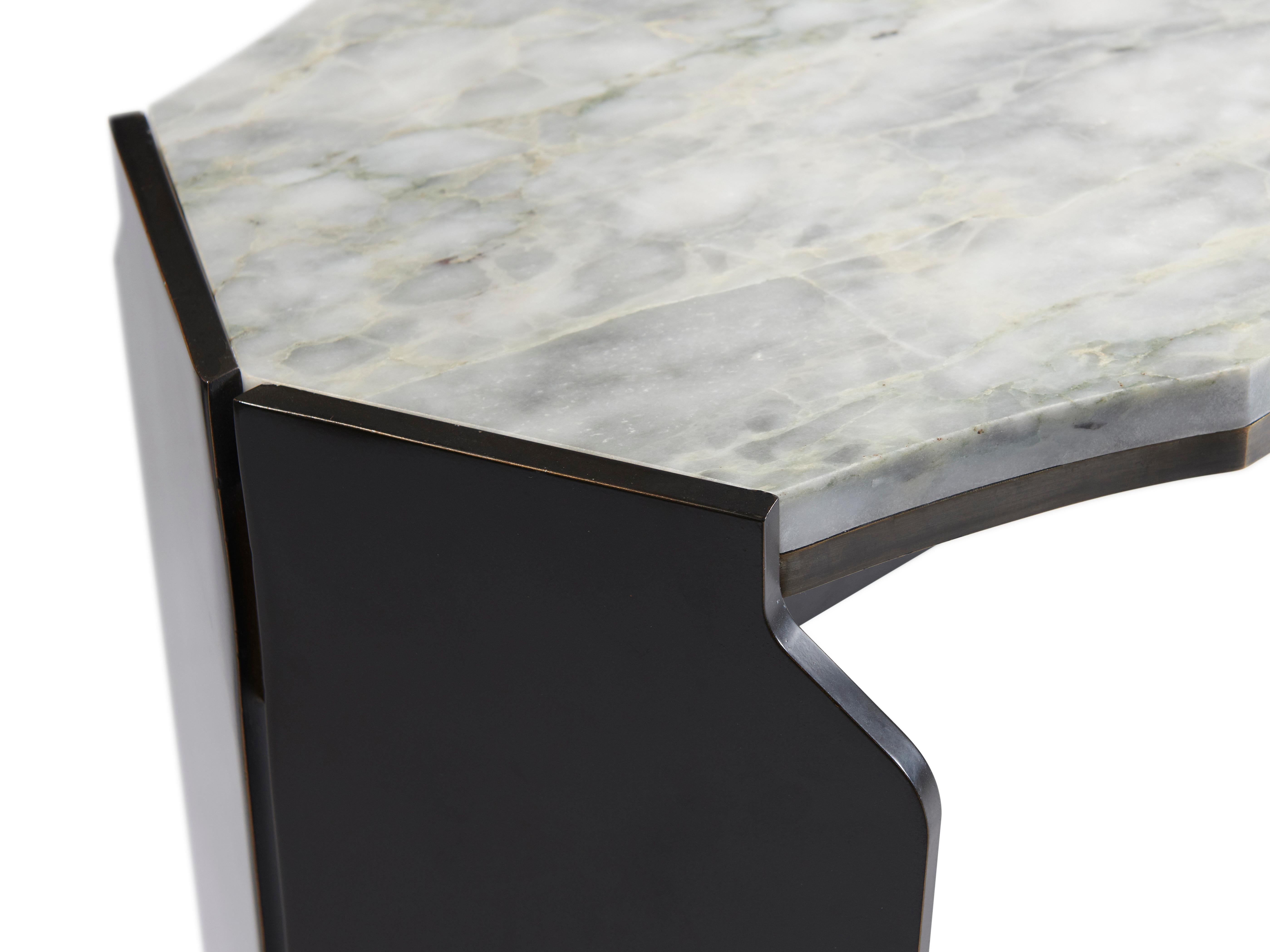 As shown in dark bronze patina and marble.

Athena console is a refined sculptural addition to any entry hall. The slender well-proportioned silhouette is reminiscent of an ancient shield and is accentuated by a negative reveal at its crest.