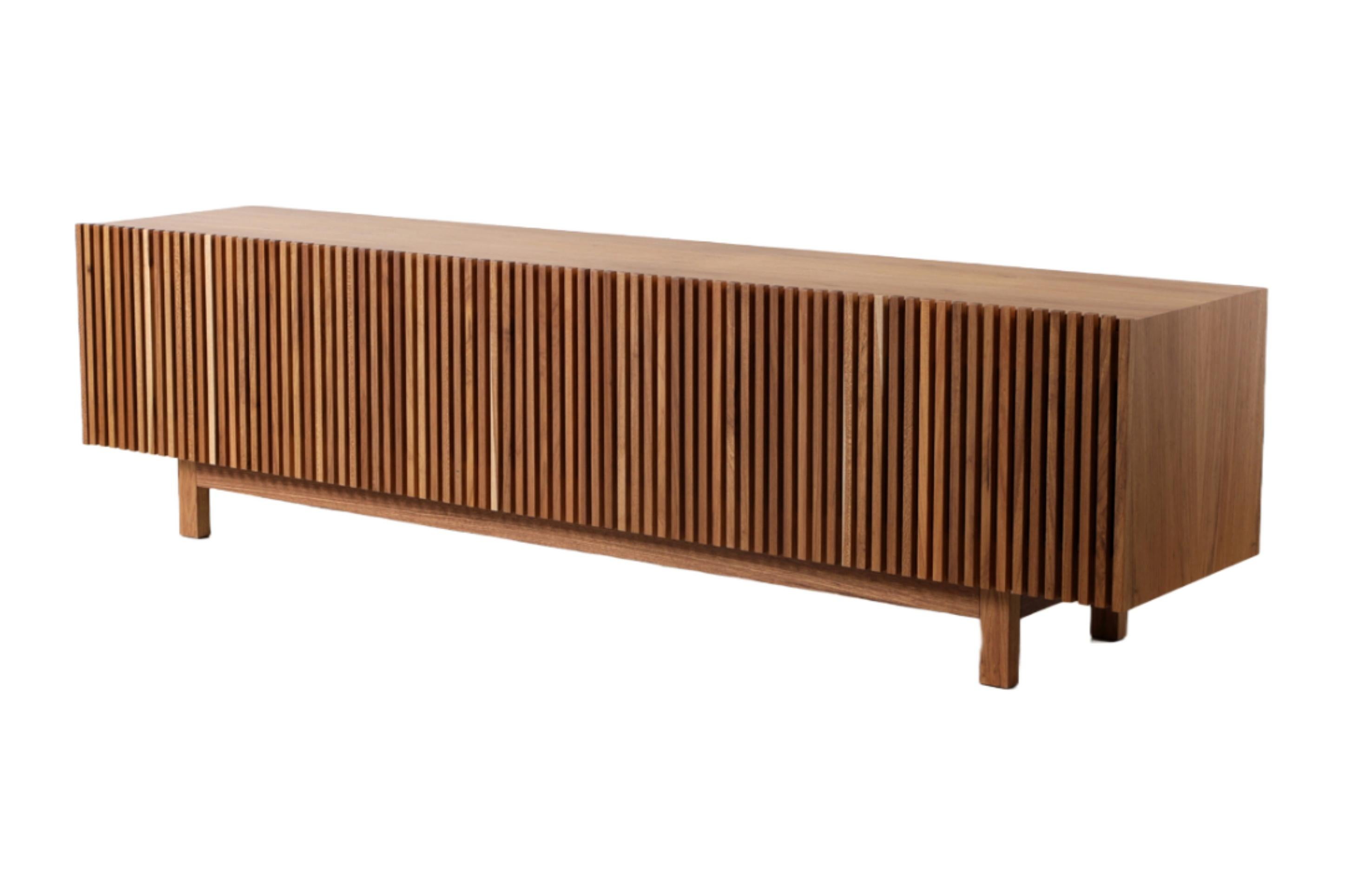 Inspired by the sun blocks or brises soleil featured on Modernist architecture which has captivated Alessandra Delgado since the early days of her career as a designer, Athena credenza design incorporates wood slat doors made using the finest