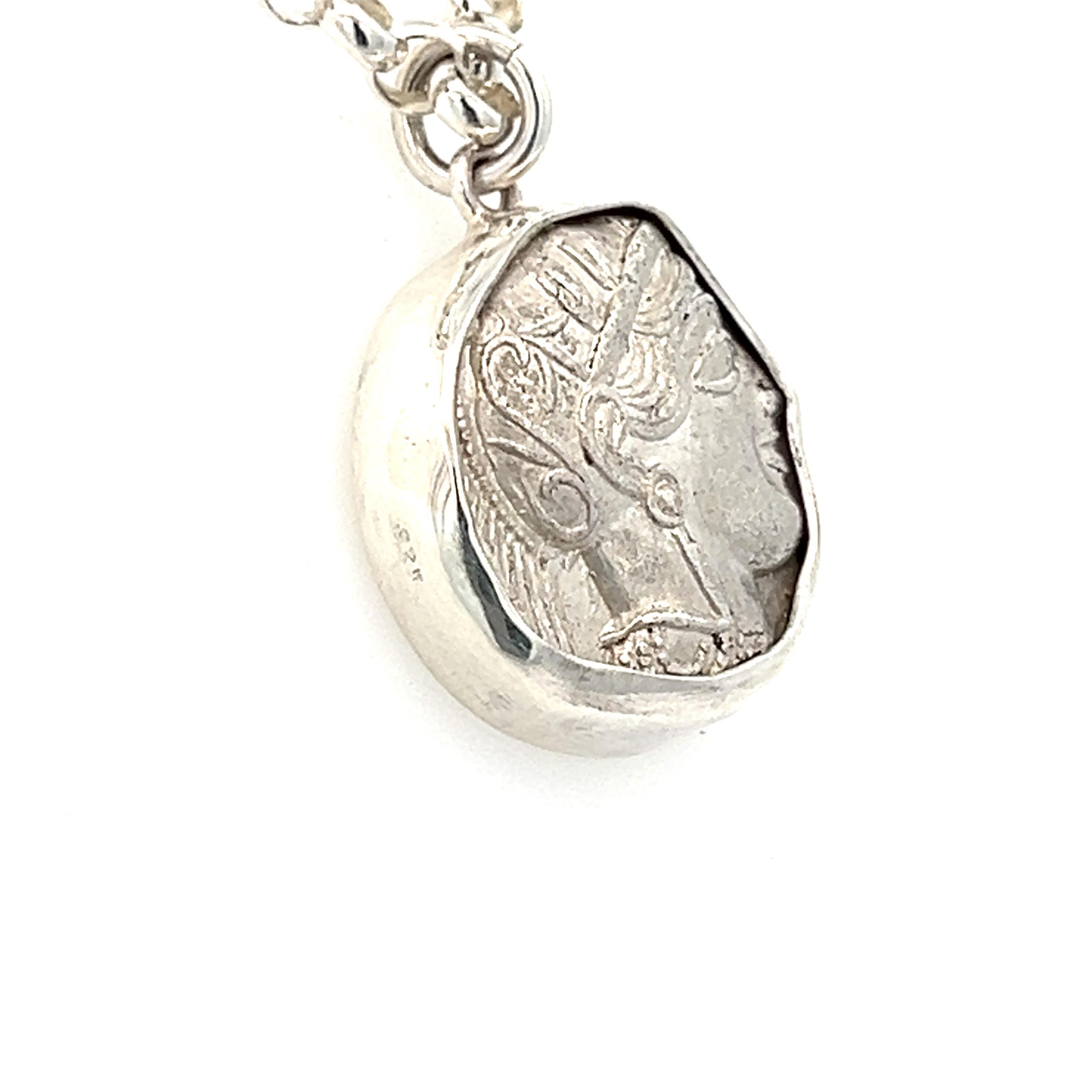 A one-of-a-kind necklace pendant created by London-based jewellery designers, Hasbani Diamonds, that combines ancient history with modern craftsmanship. The centerpiece of this stunning piece is a bespoke genuine Ancient Greek Athenian tetradrachm,