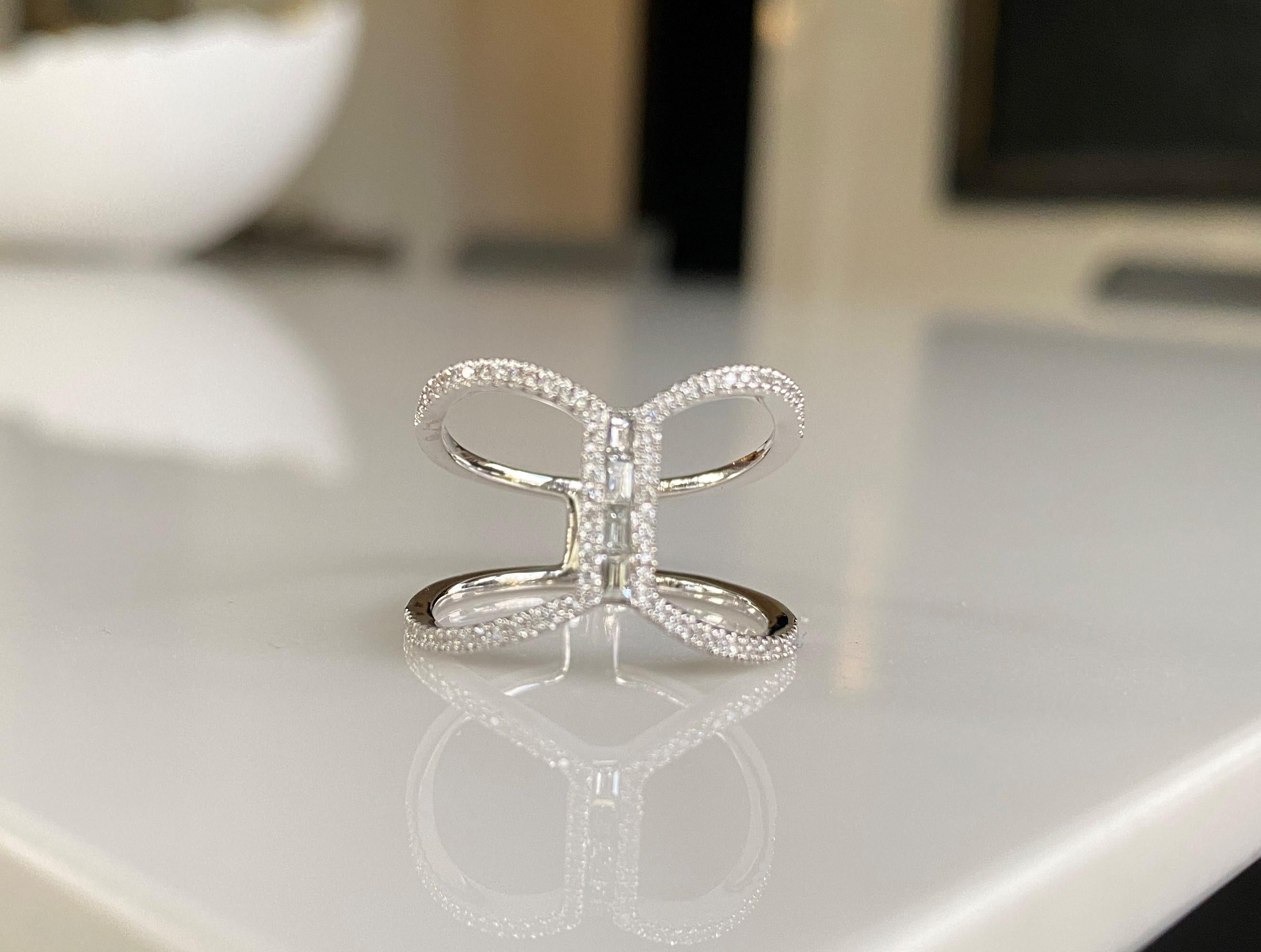 Make a statement with this exquisite ring with pave brilliant cut diamonds and generously sized white diamond baguettes. Dress up or down, wear it as a cocktail ring or alternative bridal band or engagement ring.  