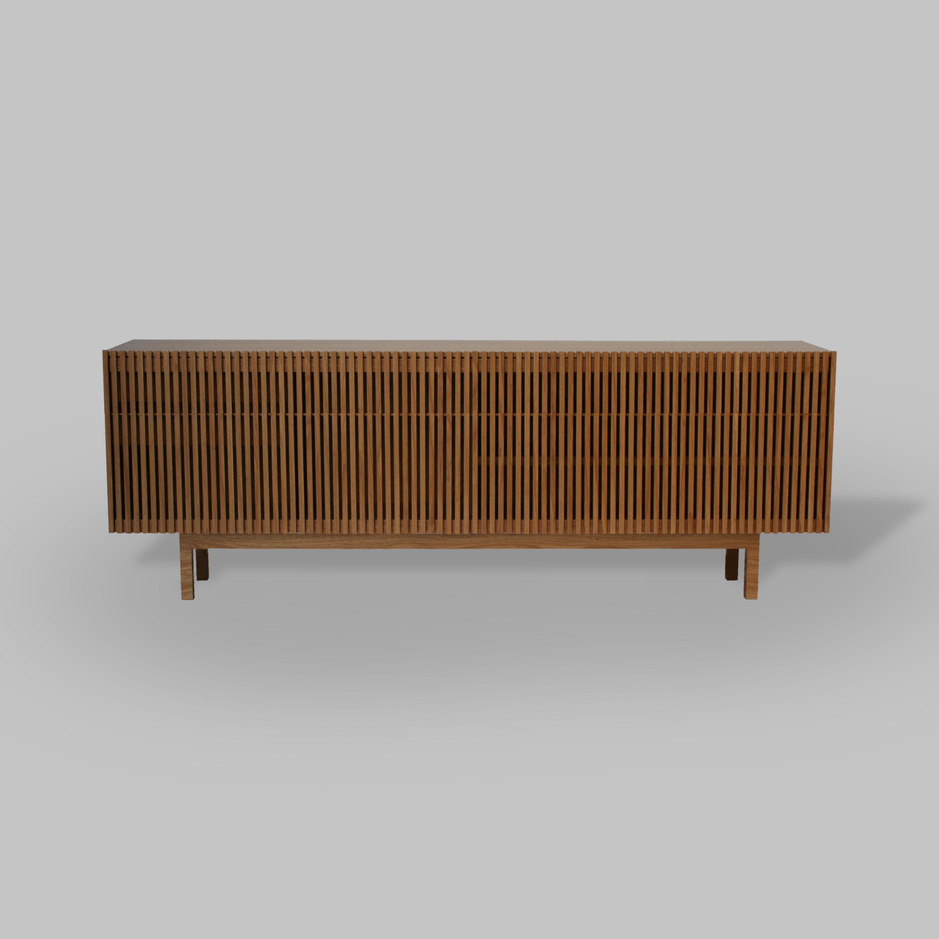 Inspired by the sun blocks or brises soleil featured on Modernist architecture which has captivated Alessandra Delgado since the early days of her career as a designer, Athena credenza design incorporates wood slat doors made using the finest