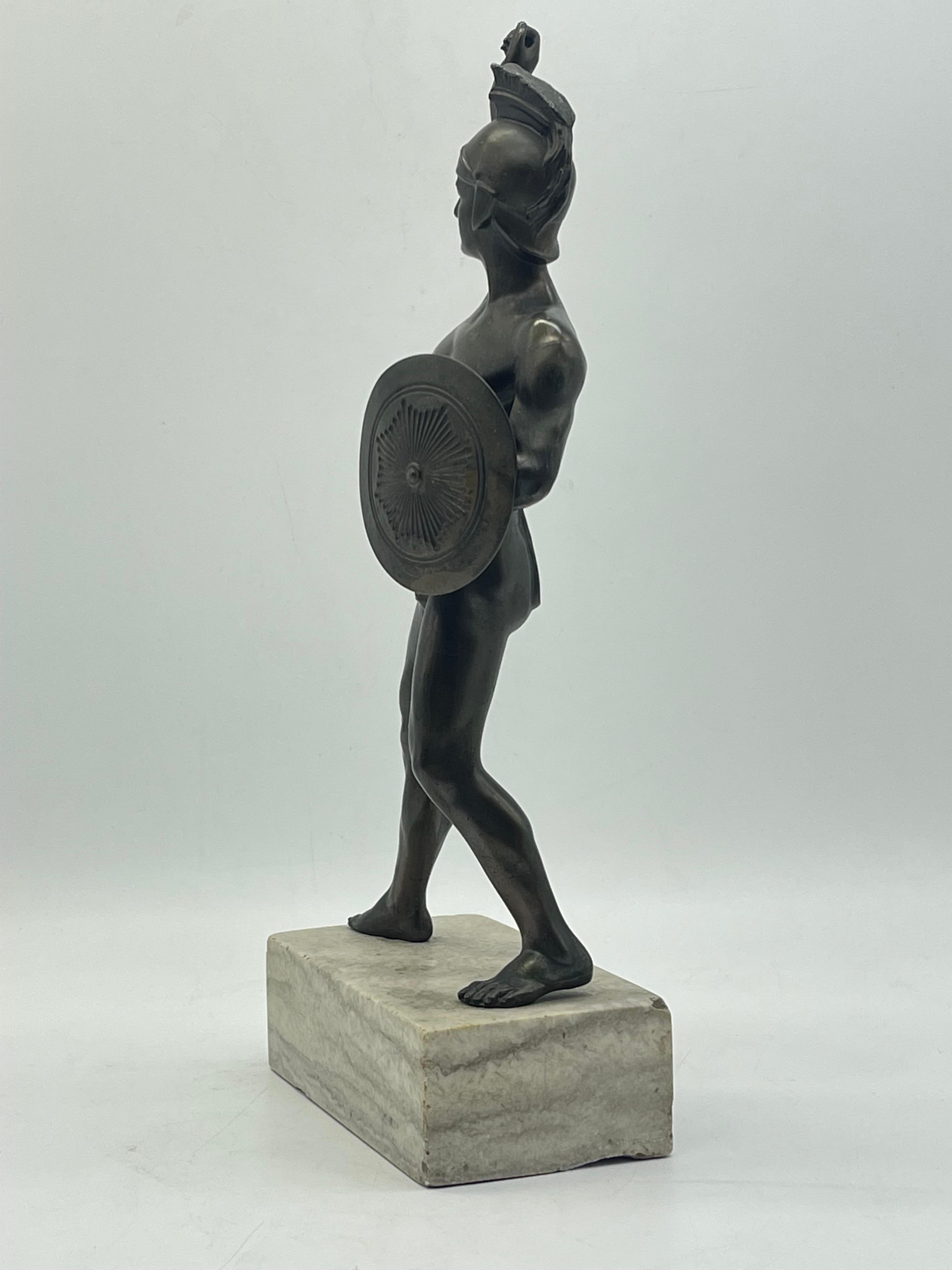 Athletic bronze Warrior sculpture on marble base Greek figure with shield In Good Condition For Sale In Berlin, DE