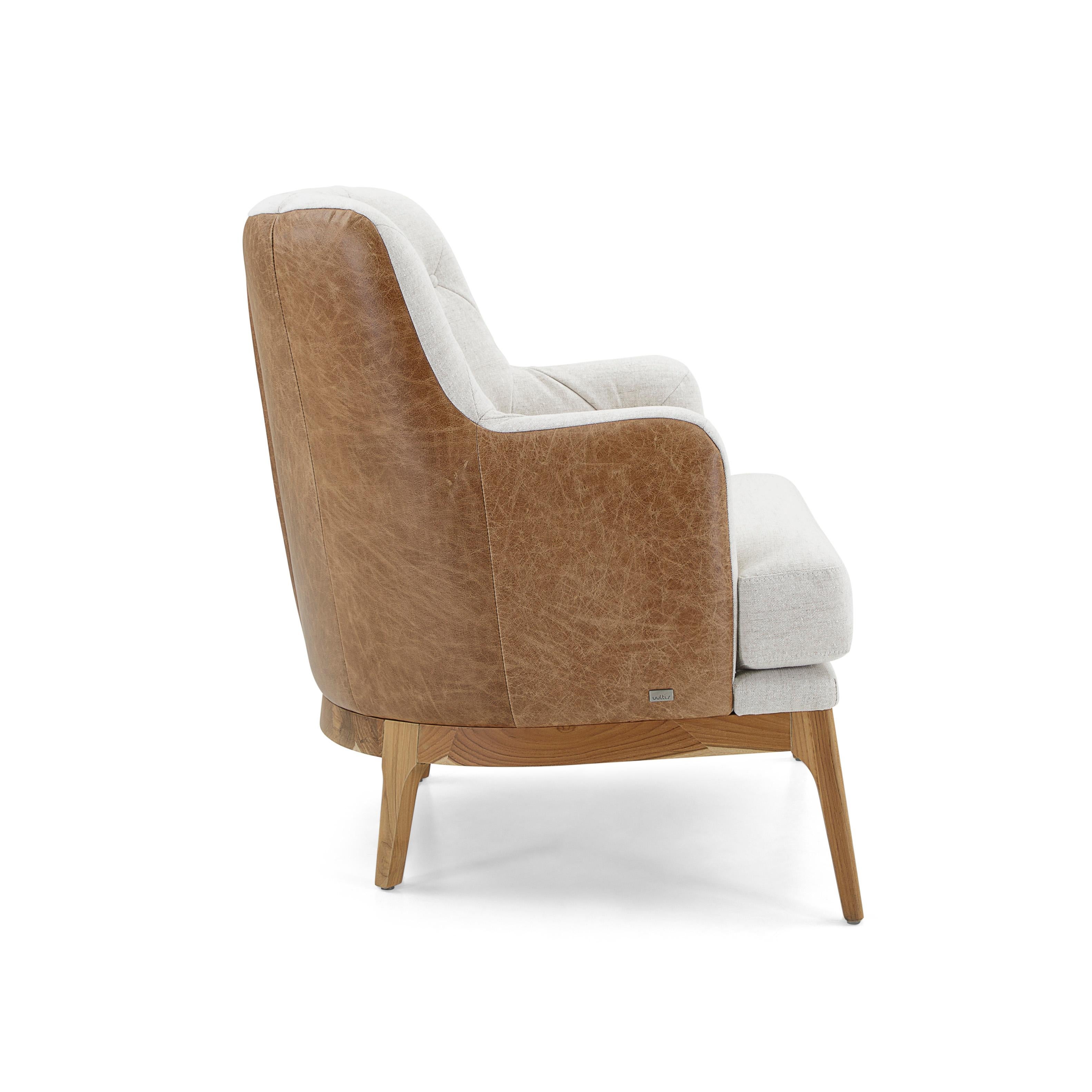 The Athos armchair is upholstered on the outside back and sides in a gorgeous brown distressed leather while the chair interior is covered in a beautiful ivory colored fabric and legs made of wood in a teak wood finish. This chair has been designed